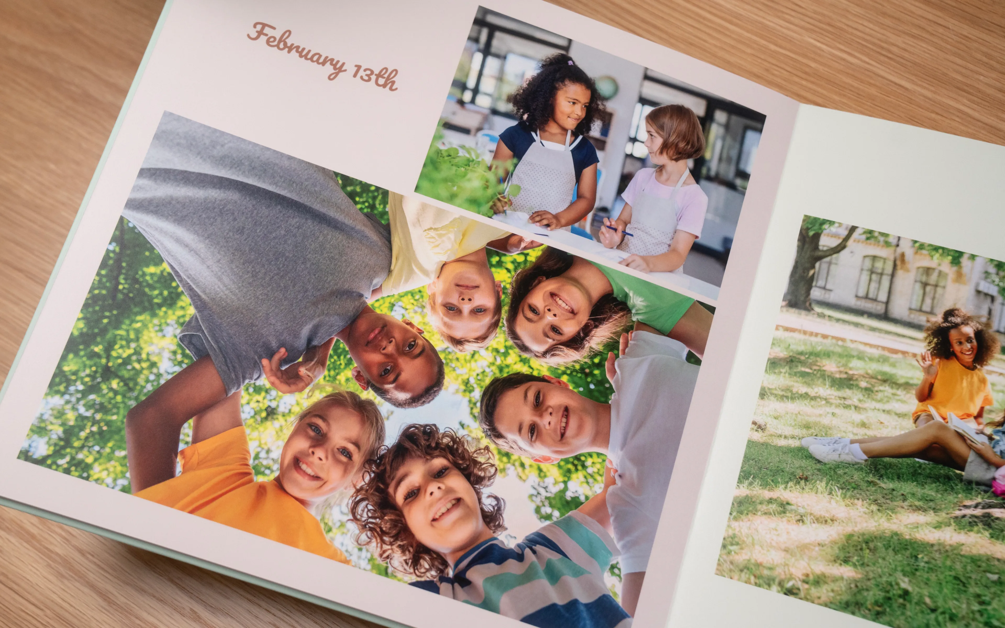 Open photo album showing kids smiling in a circle outdoors, with date "February 13th" written on the page.