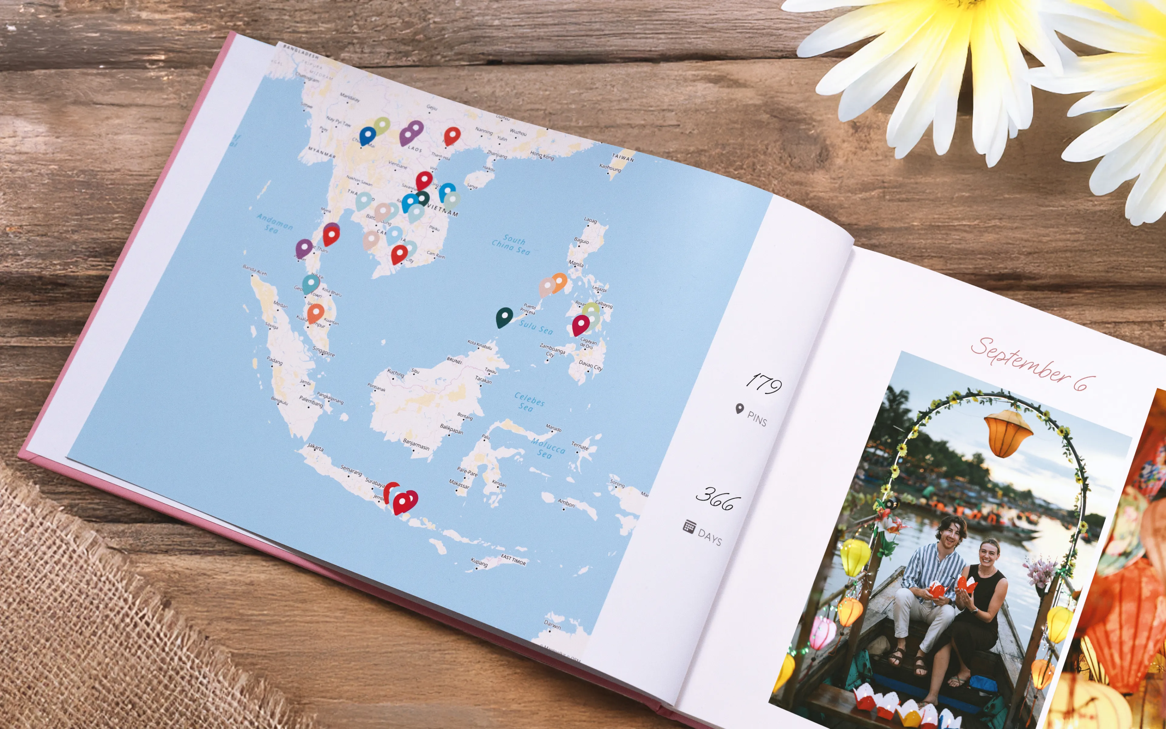 Open book with a map of Southeast Asia and travel destinations marked. Next page shows a photo of two people and the date September 6.