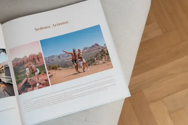 Open travel photo book on a light surface, featuring photos labeled "Sedona, Arizona" with scenic desert landscapes and people posing.