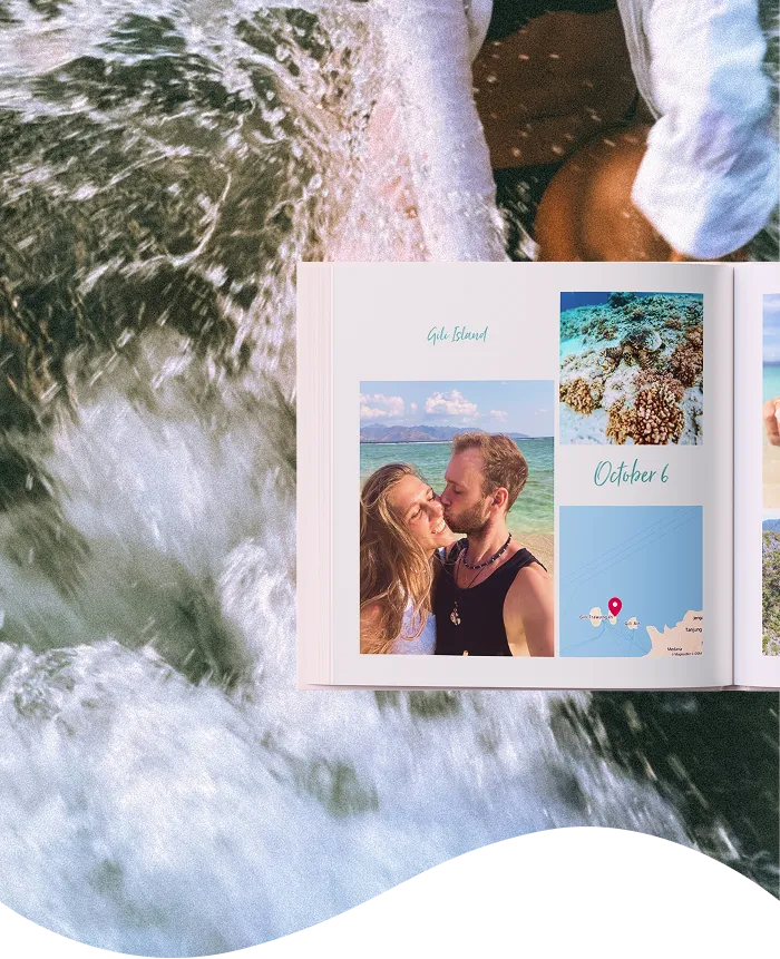 A travel photo album open on a wave-splashed shore, displaying a couple kissing, scenic beach views, and a map with a date "October 6."