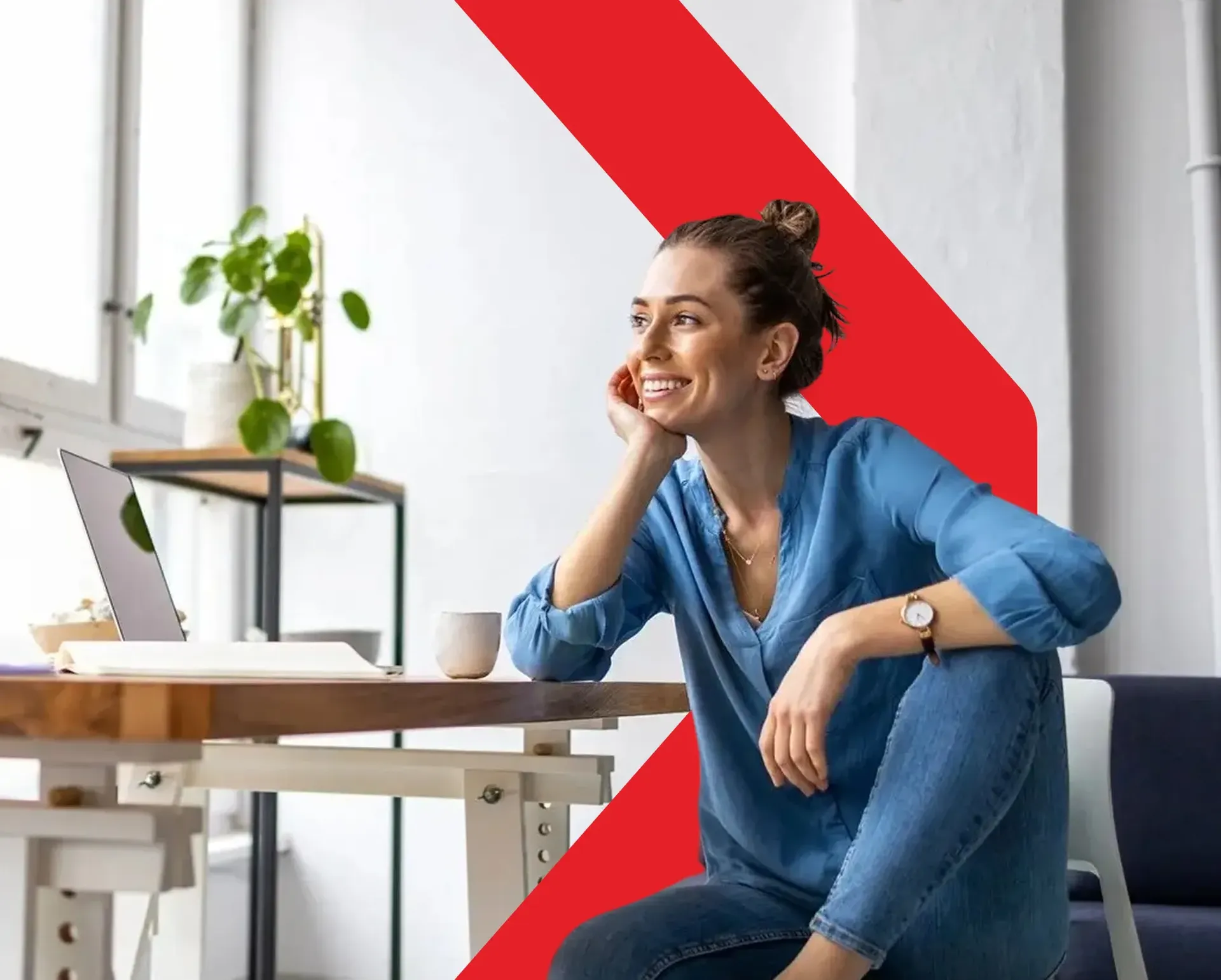 A smiling woman sitting, facing slightly sideways while looking forward with a warm expression.