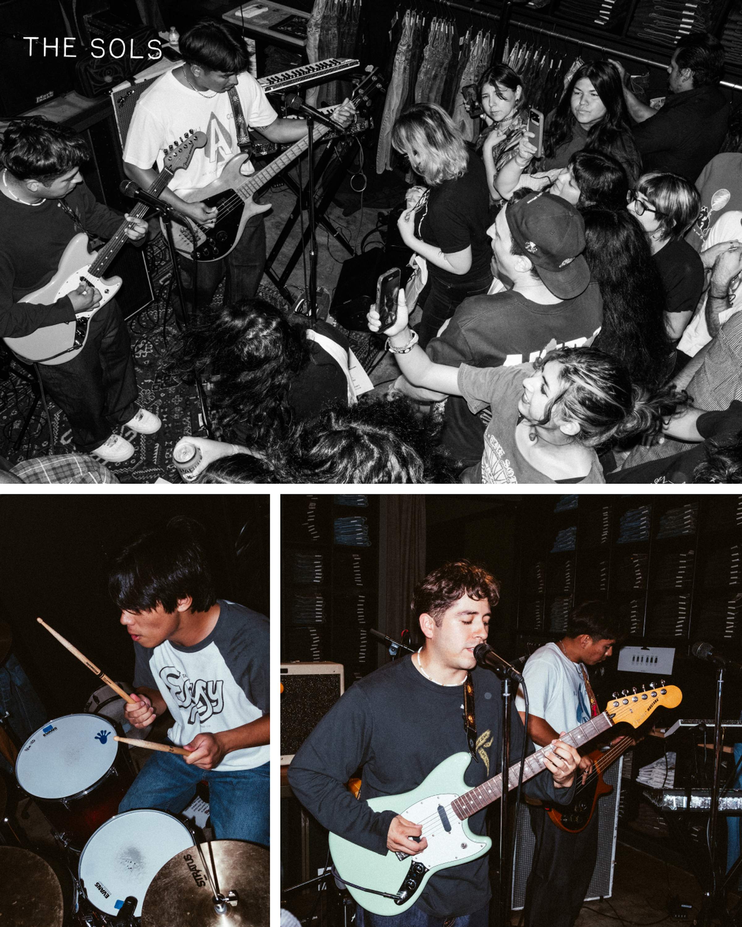 A band performing live in a small venue while a crowd gathers closely. One musician sings and plays guitar, another plays drums.