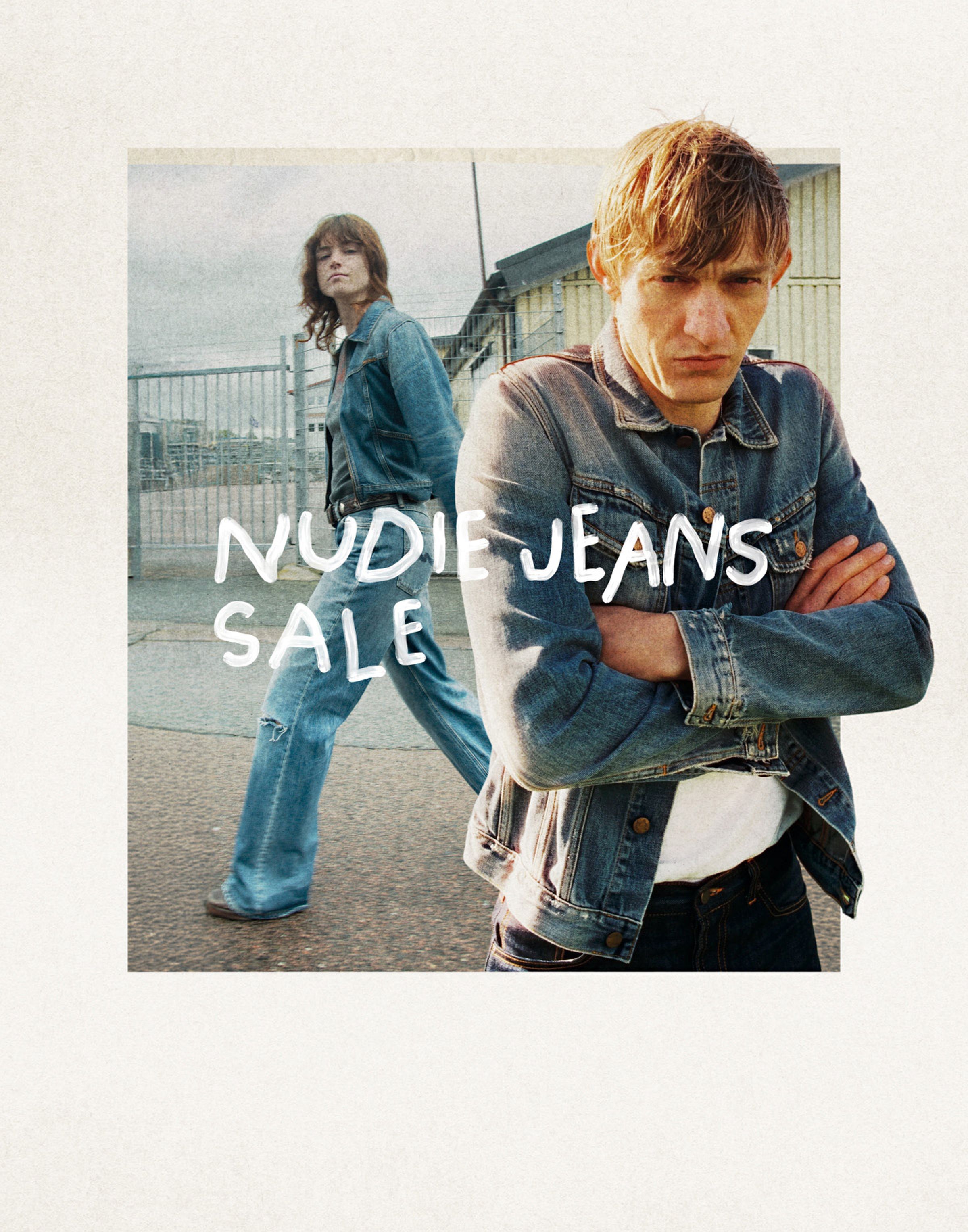 Two people in denim jackets and jeans, one walking and one with crossed arms. Text reads "Nudie Jeans Sale." Background shows an urban setting.