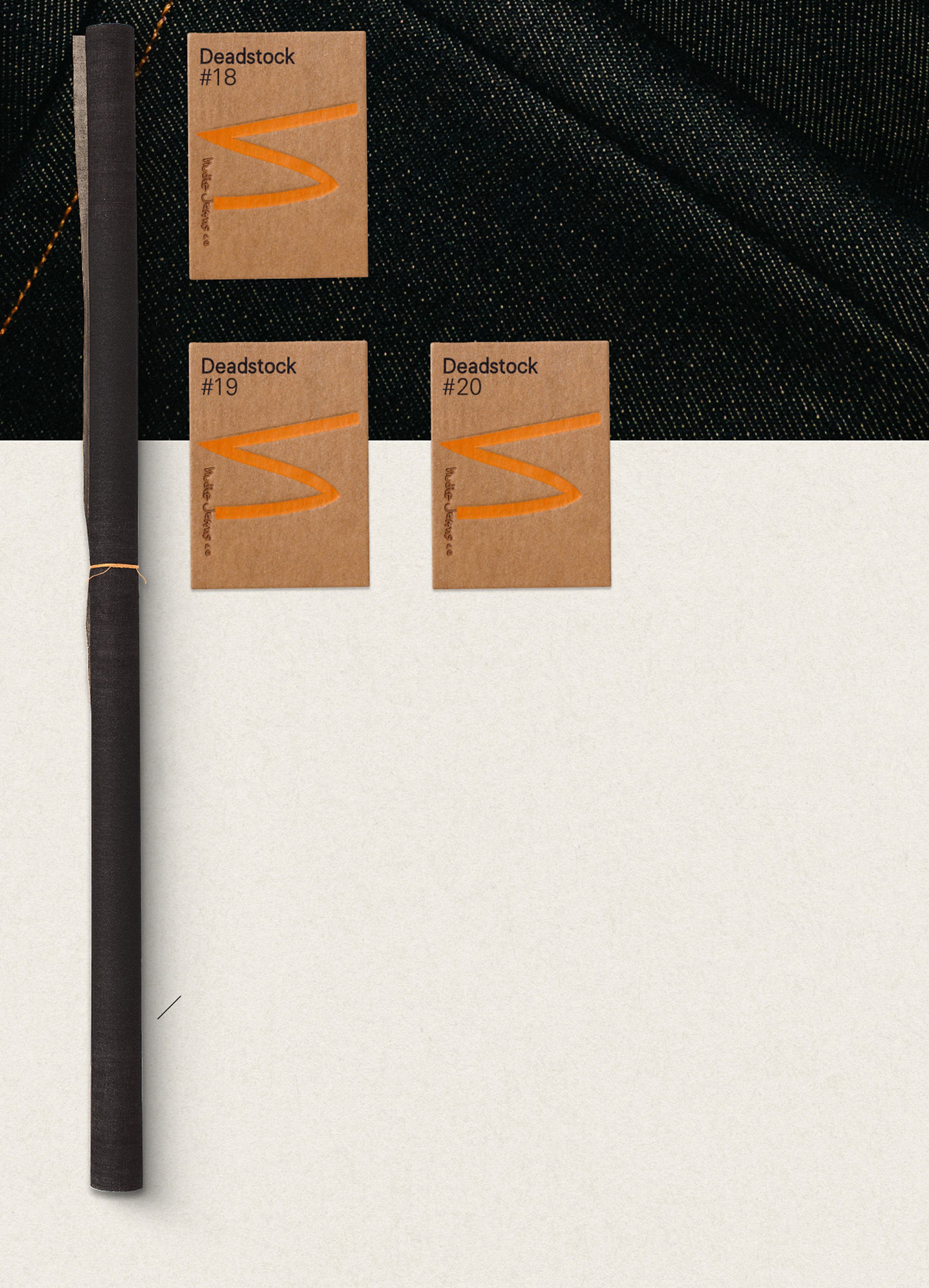 Three brown cards labeled "Deadstock #18," "#19," and "#20" on denim fabric, with a rolled black fabric on the left.