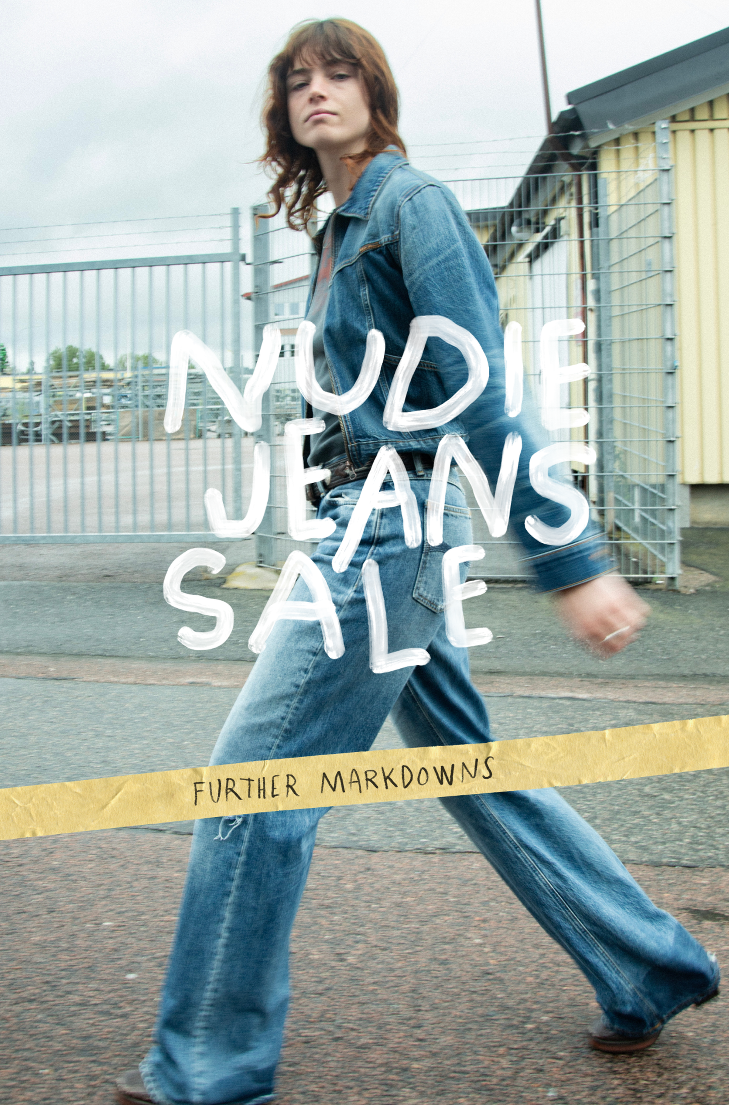Person in denim outfit walking past a fence with "Nudie Jeans Sale" and "Further Markdowns" text overlayed.
