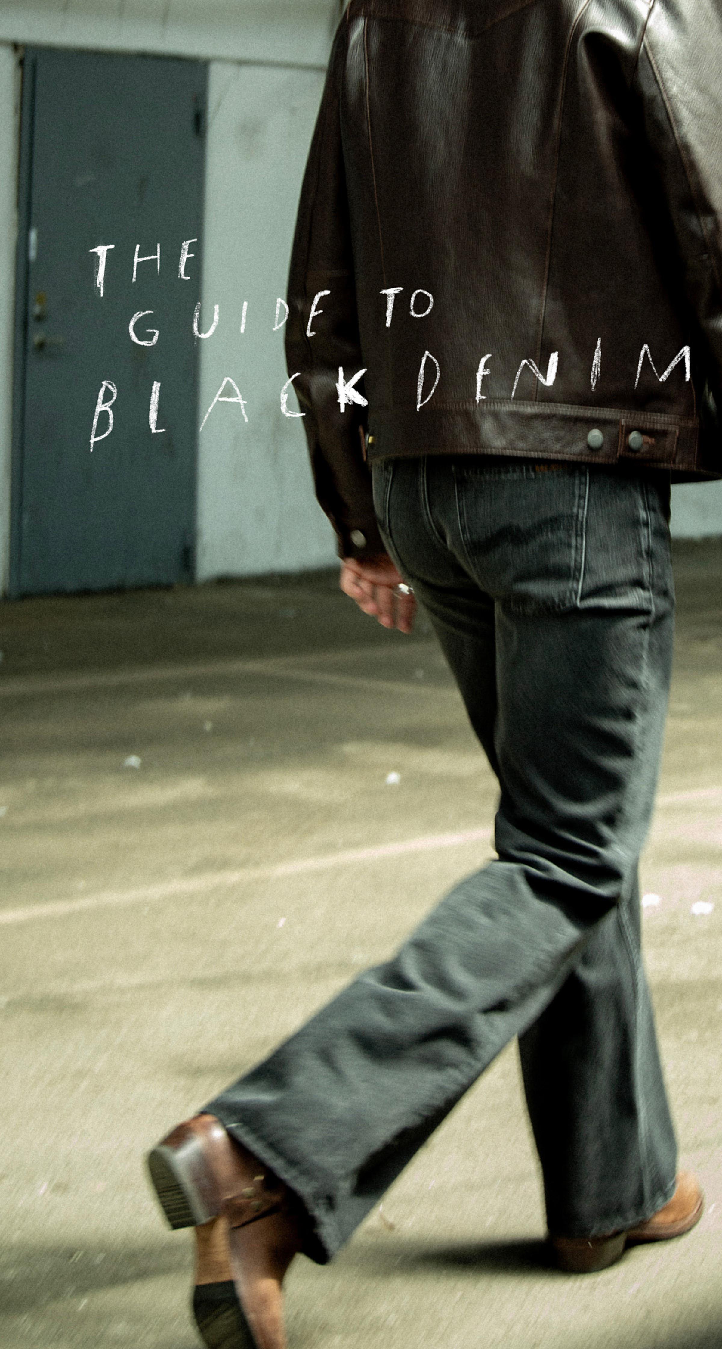 Person in a brown leather jacket and black denim jeans walking, with text overlay: "The Guide to Black Denim."