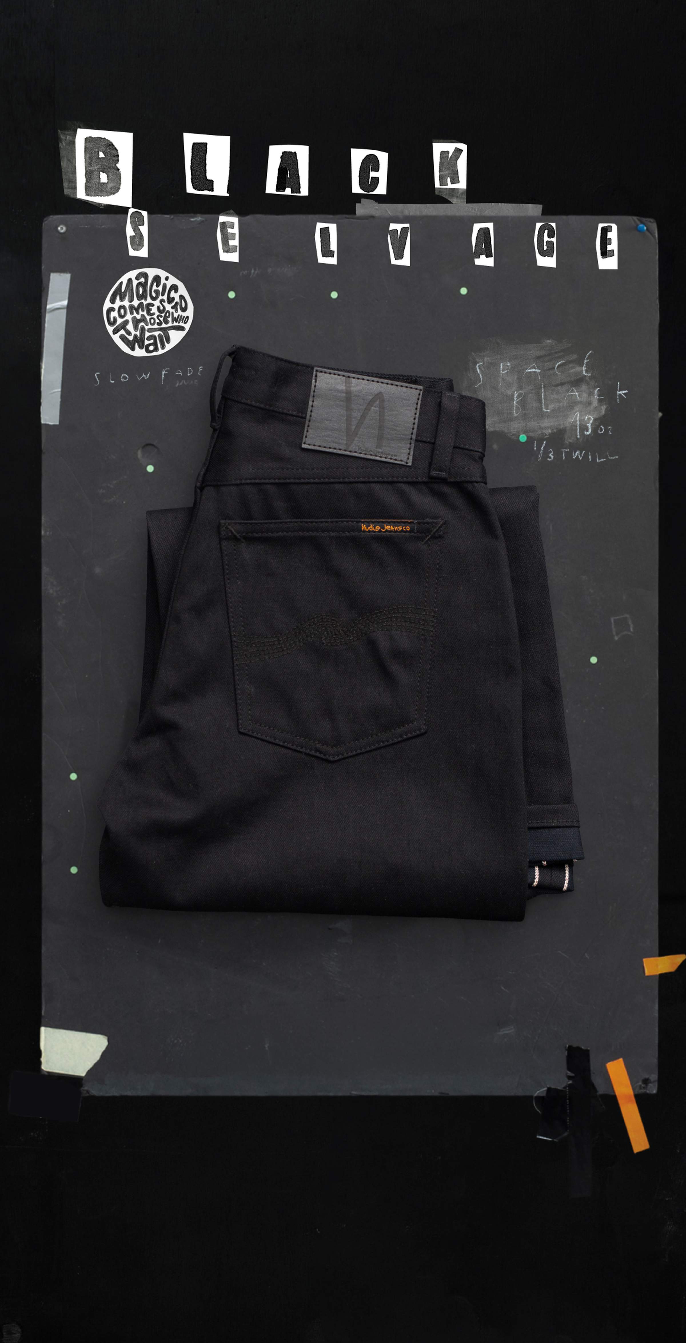 Folded black jeans on a dark background with "Black Selvage" text and patches displayed above.