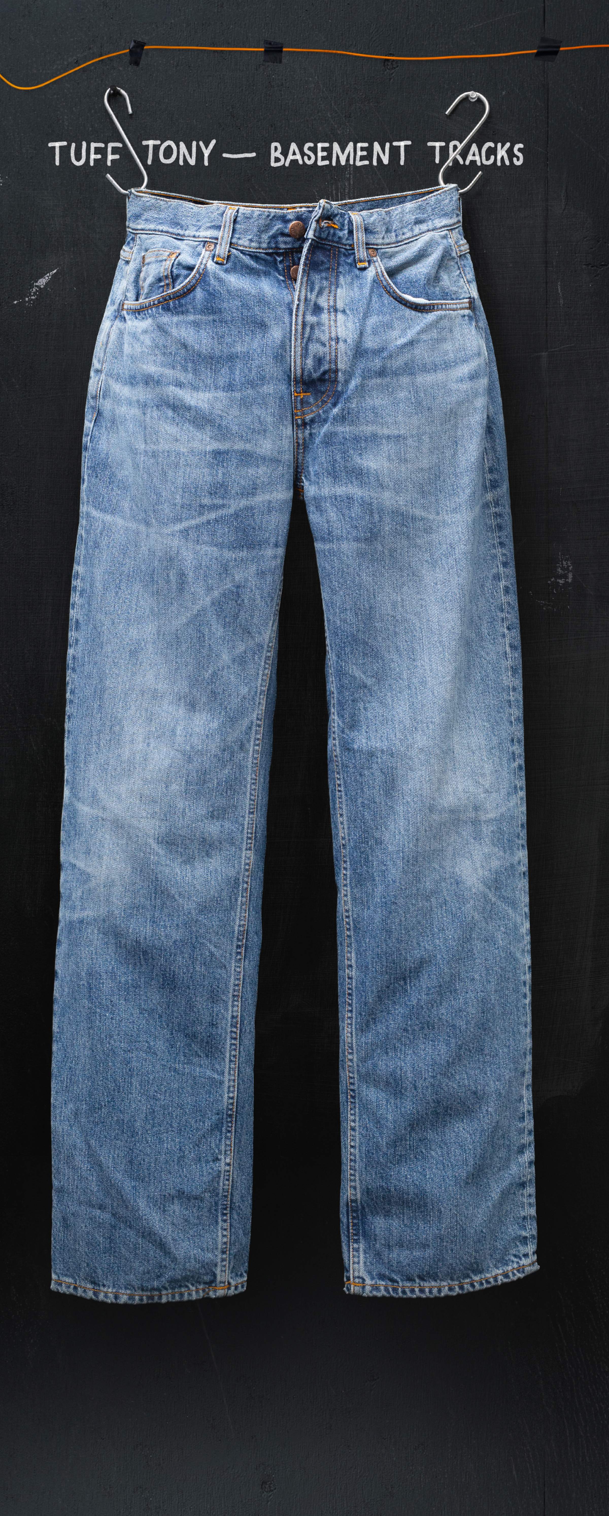 Faded blue jeans hanging against a dark background with text "Tuff Tony - Basement Tracks" above.