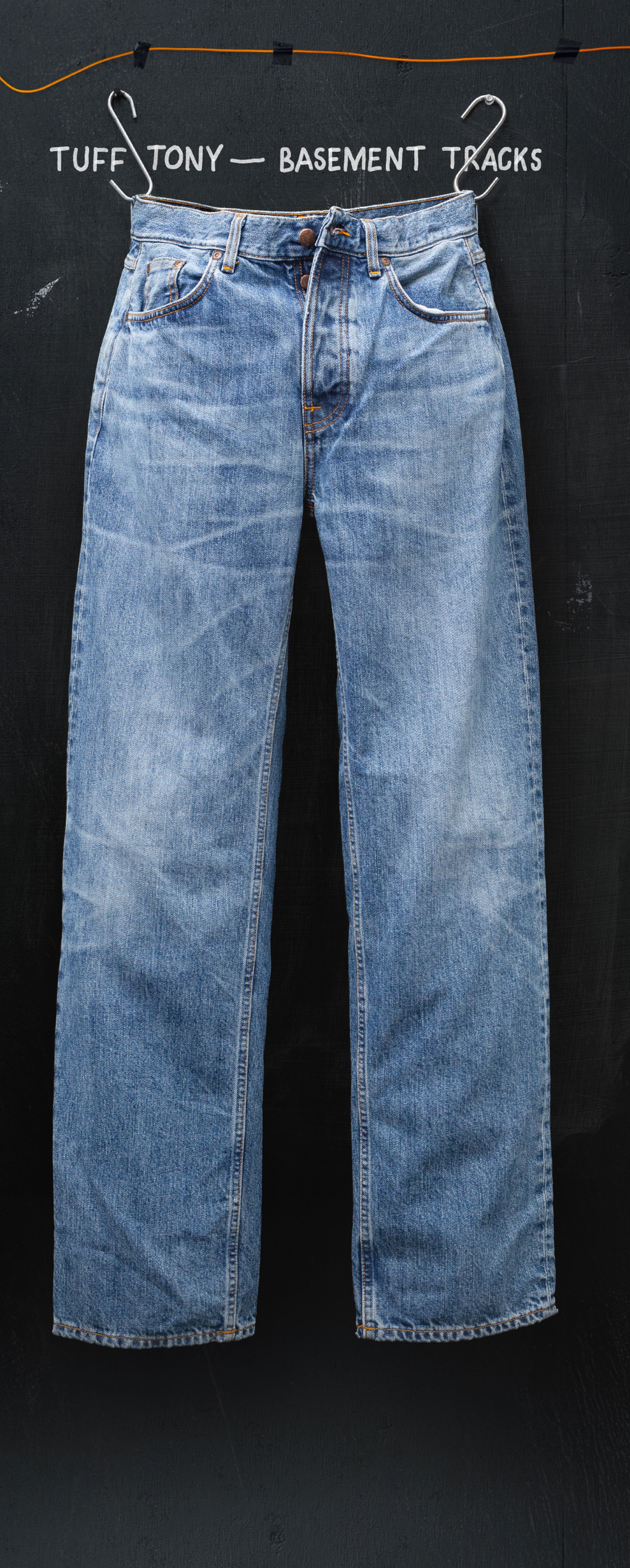 Faded blue jeans hanging against a dark background with text "Tuff Tony - Basement Tracks" above.