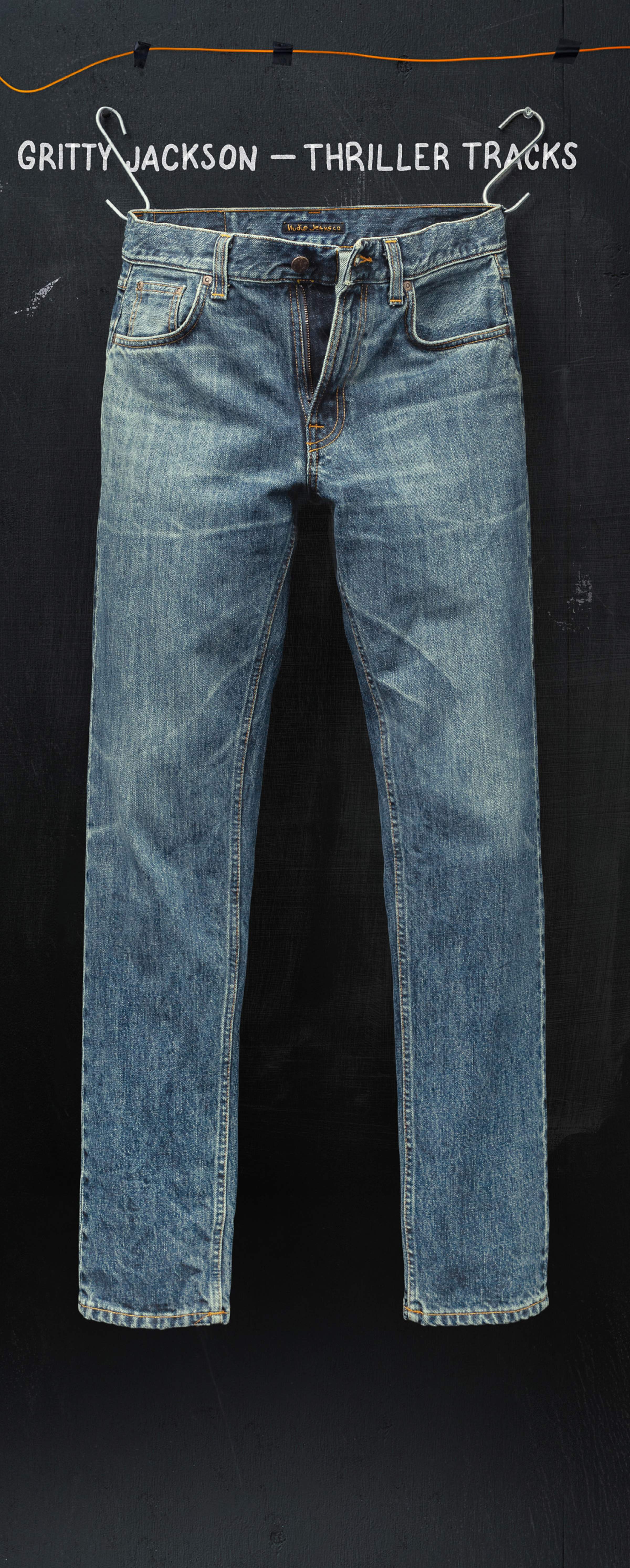 A pair of blue jeans hanging against a dark background, with text "Gritty Jackson - Thriller Tracks" above.
