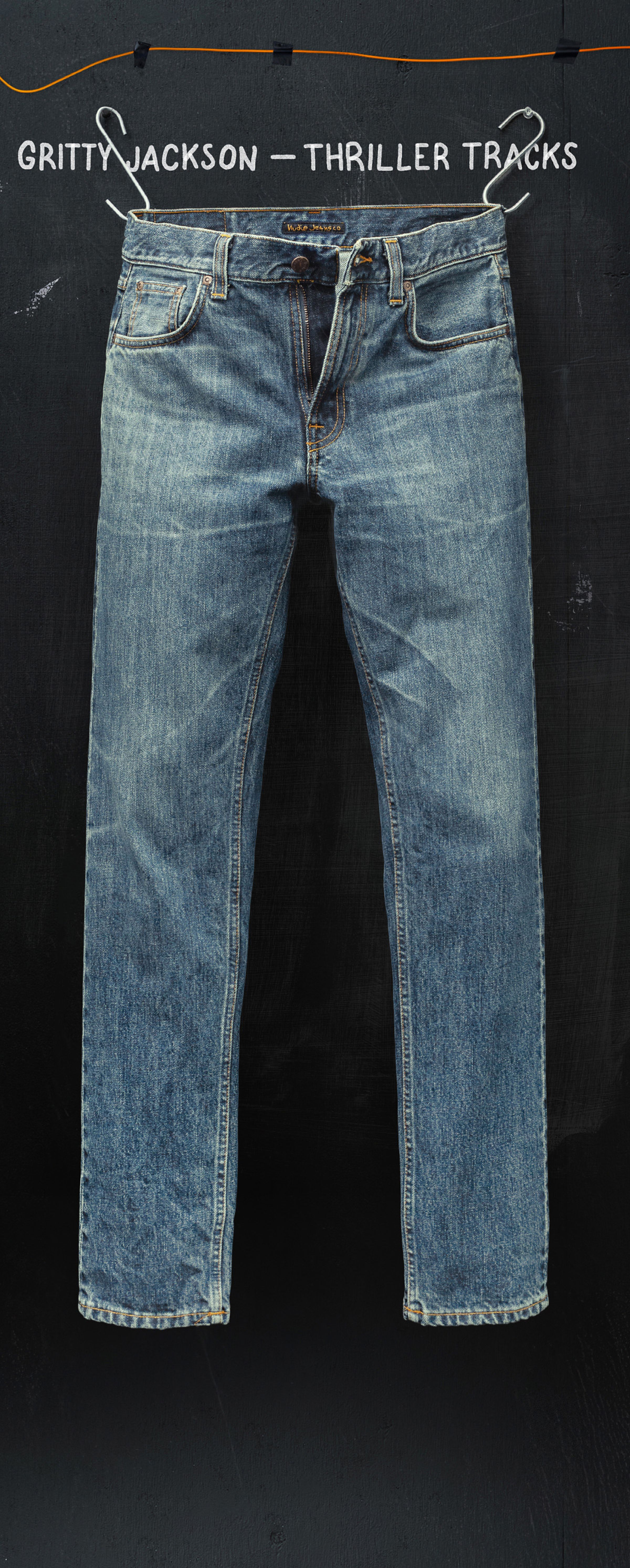 A pair of blue jeans hanging against a dark background, with text "Gritty Jackson - Thriller Tracks" above.