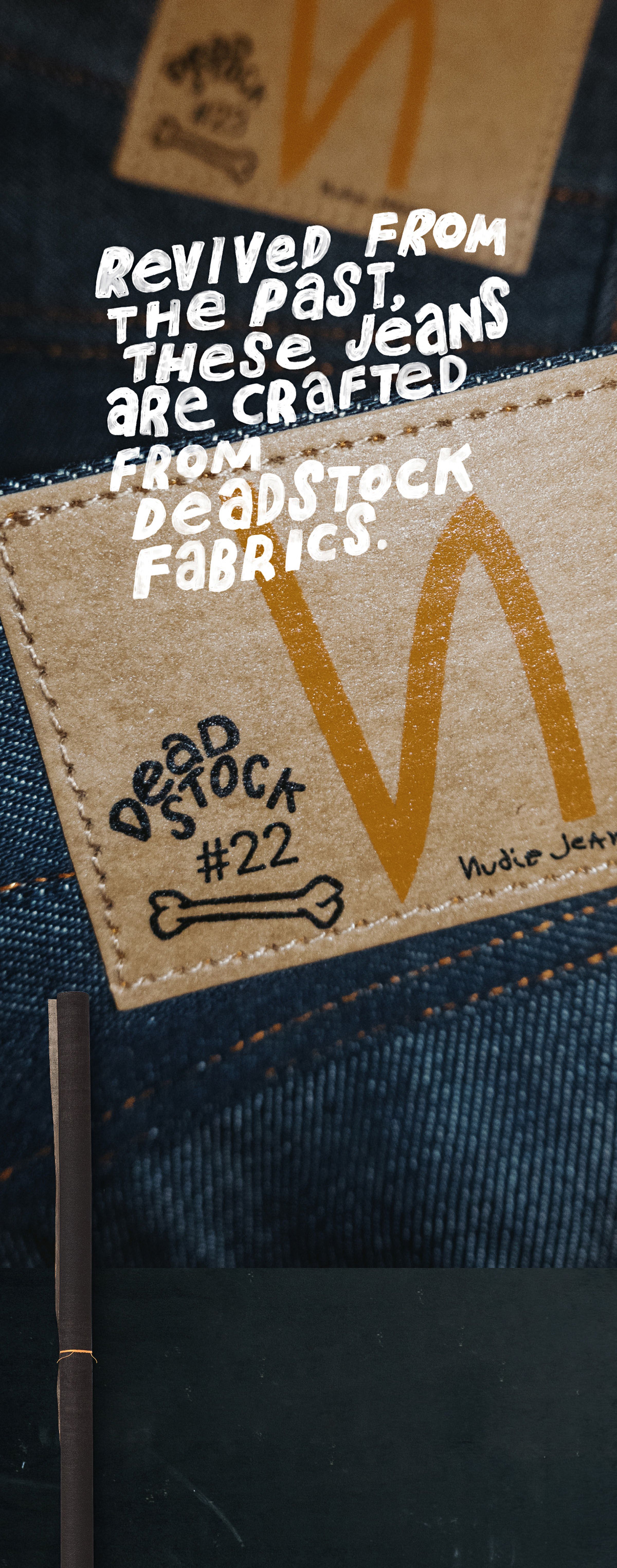 Close-up of a denim patch with text: "Deadstock #22" and "Revived from the past, these jeans are crafted from deadstock fabrics."