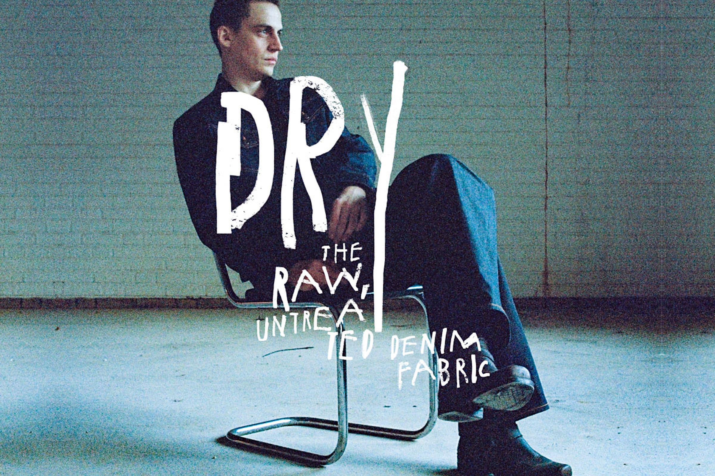 Person sitting on a chair in a minimalistic room, with text overlay about raw, untreated denim fabric.
