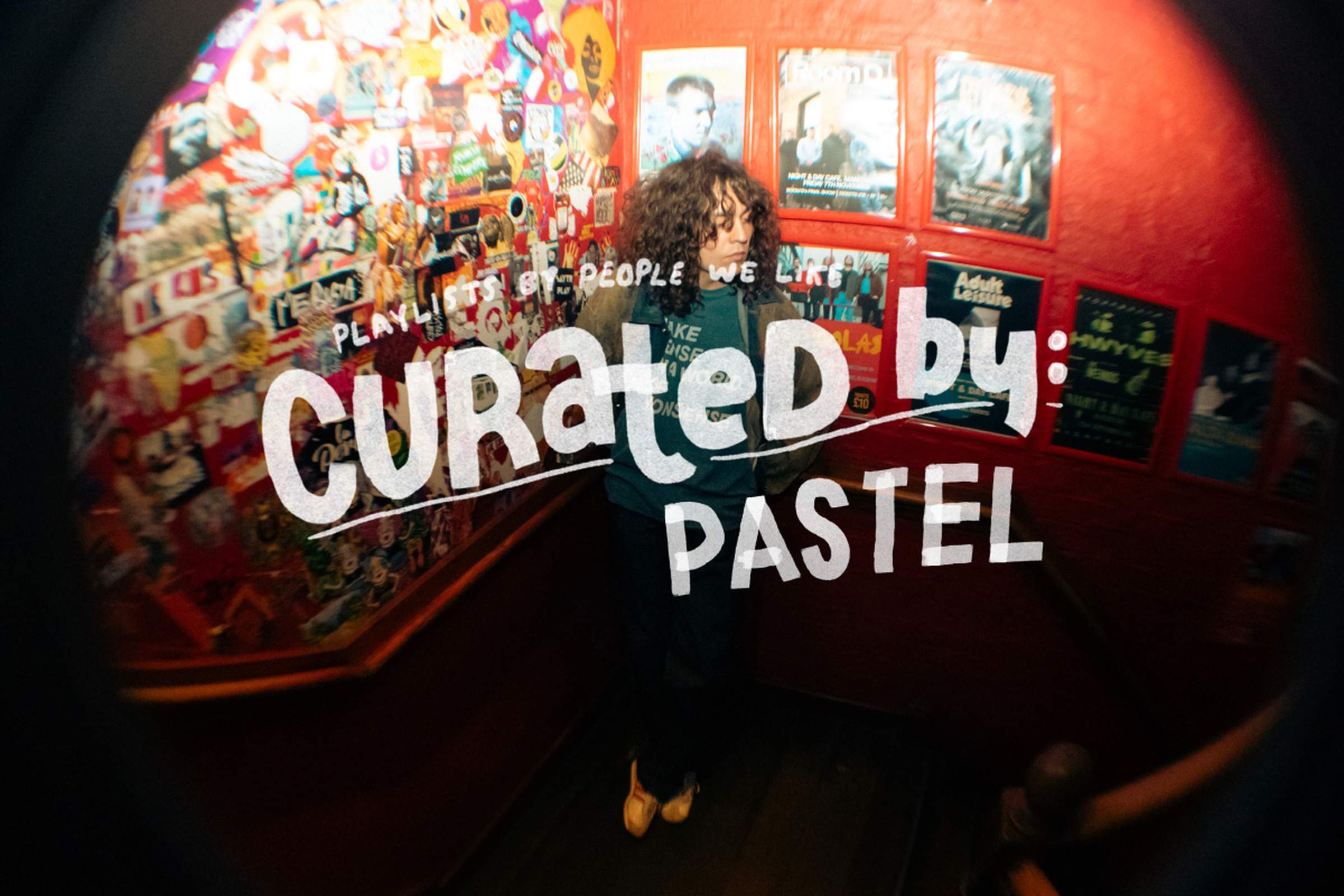 A sticker-covered red stairwell, large white text overlay reads "Curated by: PASTEL."