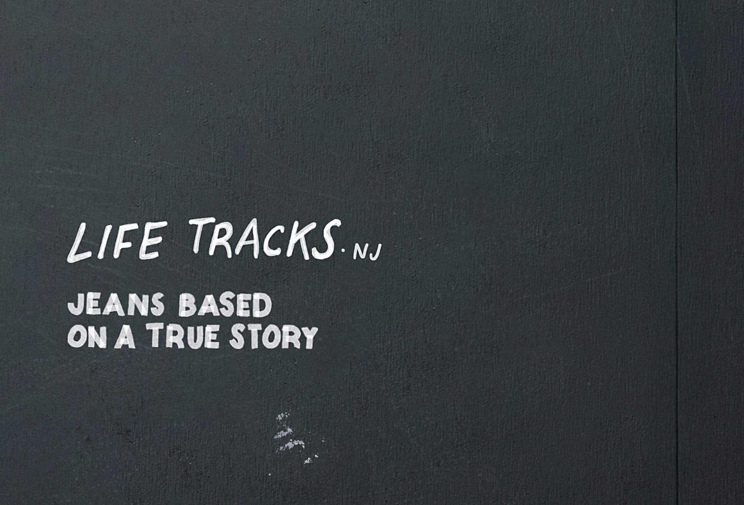 Text on a dark background reads "LIFE TRACKS.NJ JEANS BASED ON A TRUE STORY" in white, handwritten-style font.