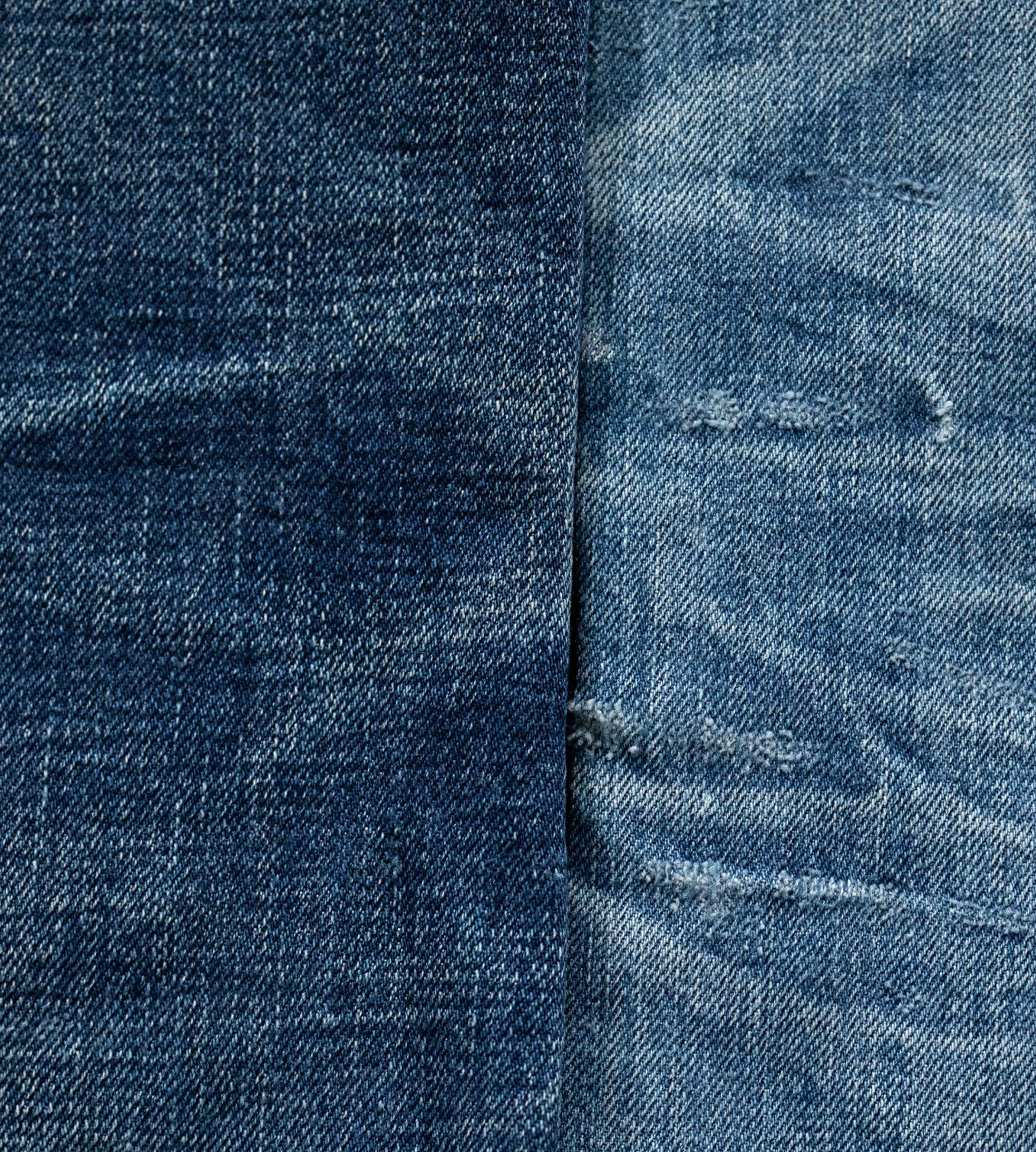 Close-up of faded Ace Selvage jeans and Dry Selvage Kaihara Jeans with visible stitching and a central seam, showcasing a worn texture and slight color variations.