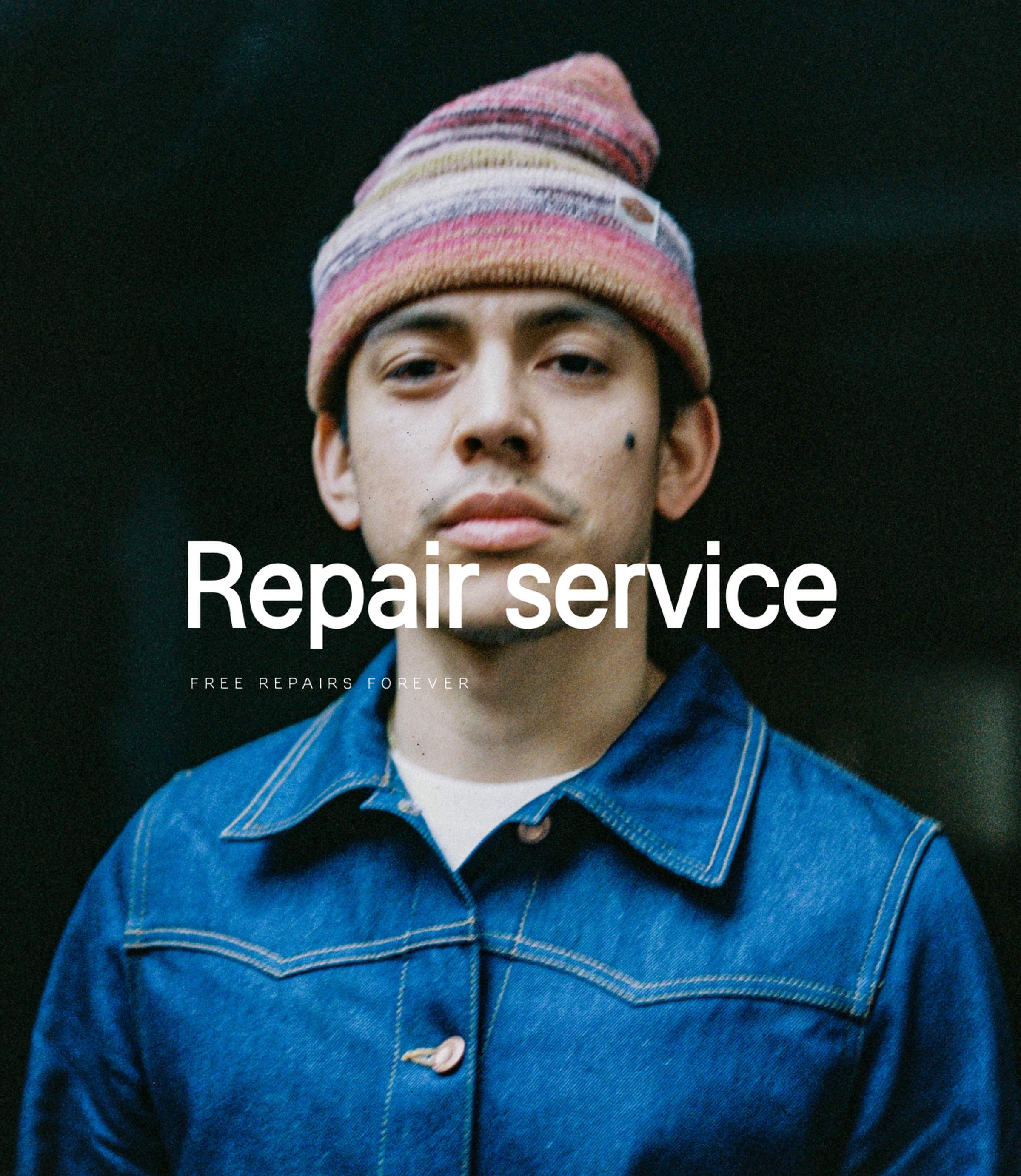 Model in blue Nudie Jeans denim jacket and striped knit beanie, 'Repair service, free repairs forever'.