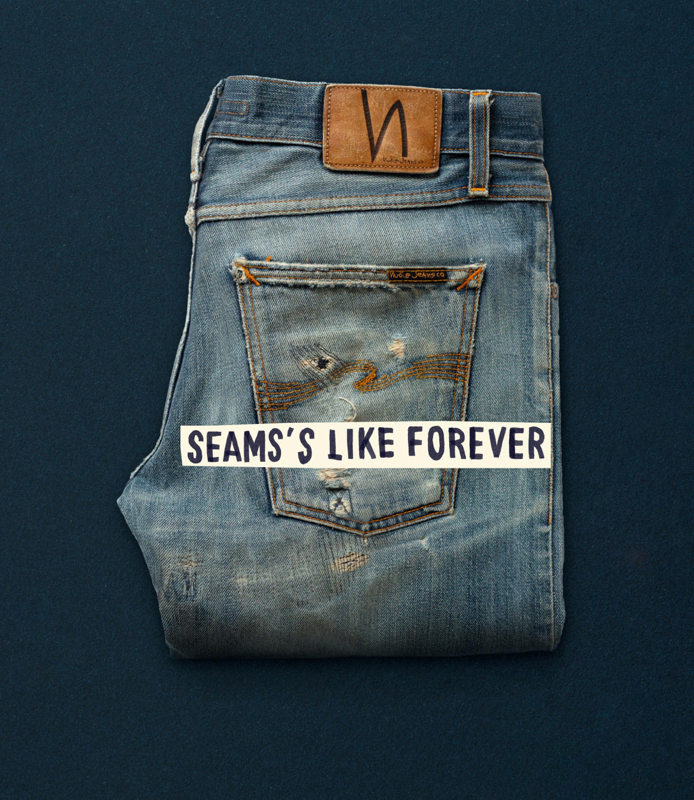 Folded distressed jeans with visible wear and a leather patch, placed on a dark surface. Text overlay reads, "SEAMS'S LIKE FOREVER."