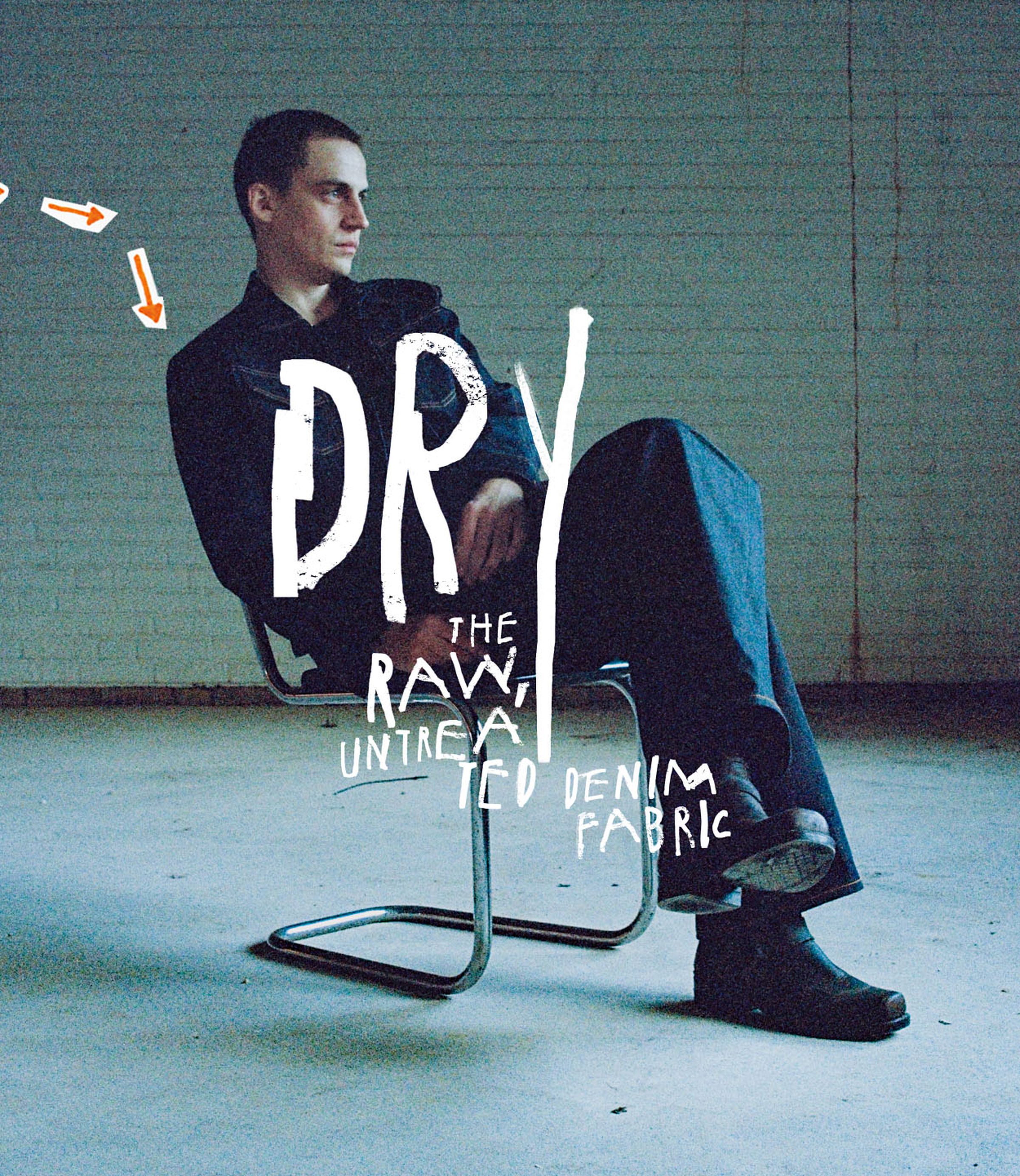Person sitting on a metal chair in a dimly lit room, wearing dark clothing. Text overlay reads: "DRY: The Raw, Untreated Denim Fabric."