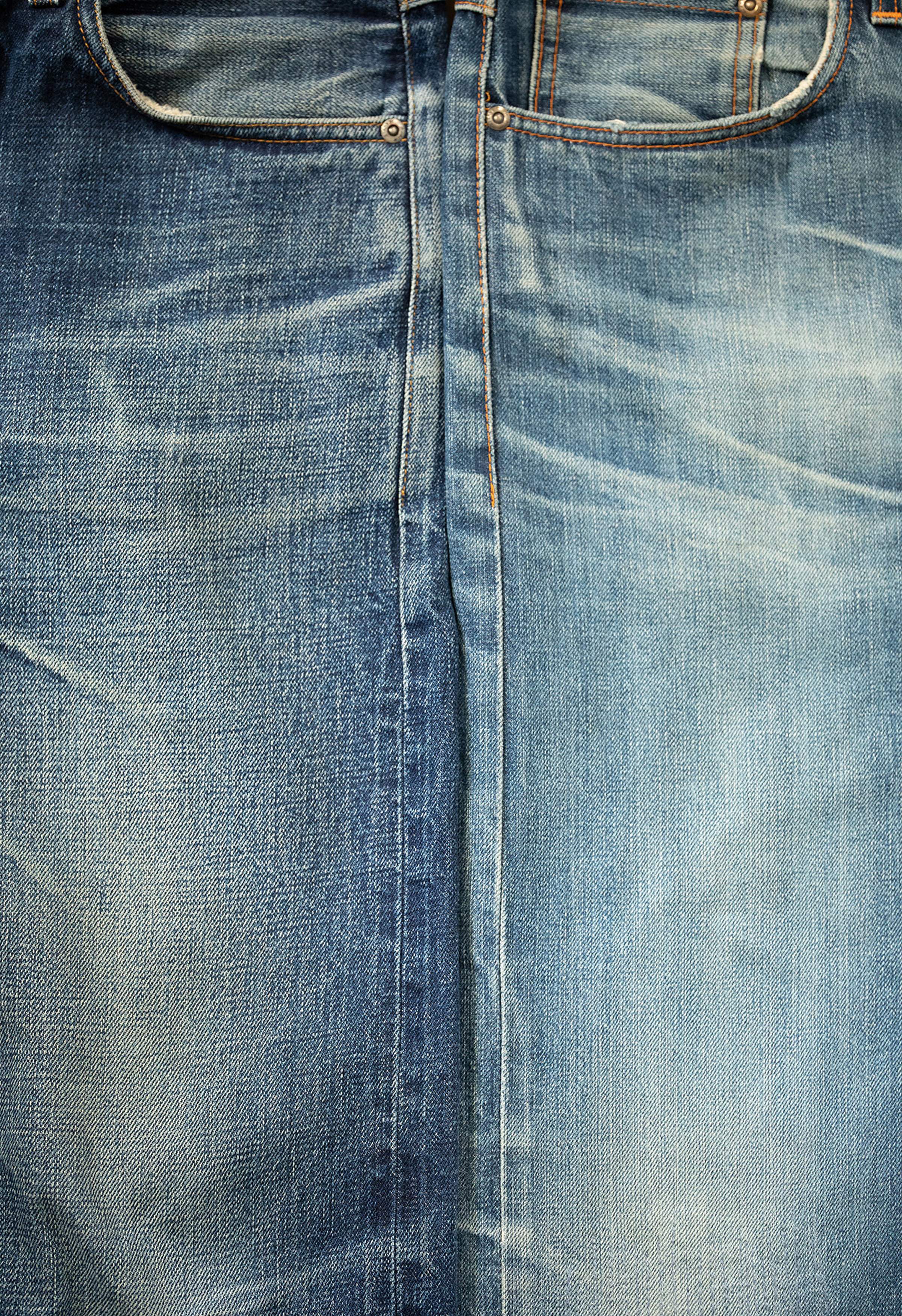 Close-up of faded Ace Selvage jeans and Dry Selvage Kaihara Jeans with visible stitching and a central seam, showcasing a worn texture and slight color variations.