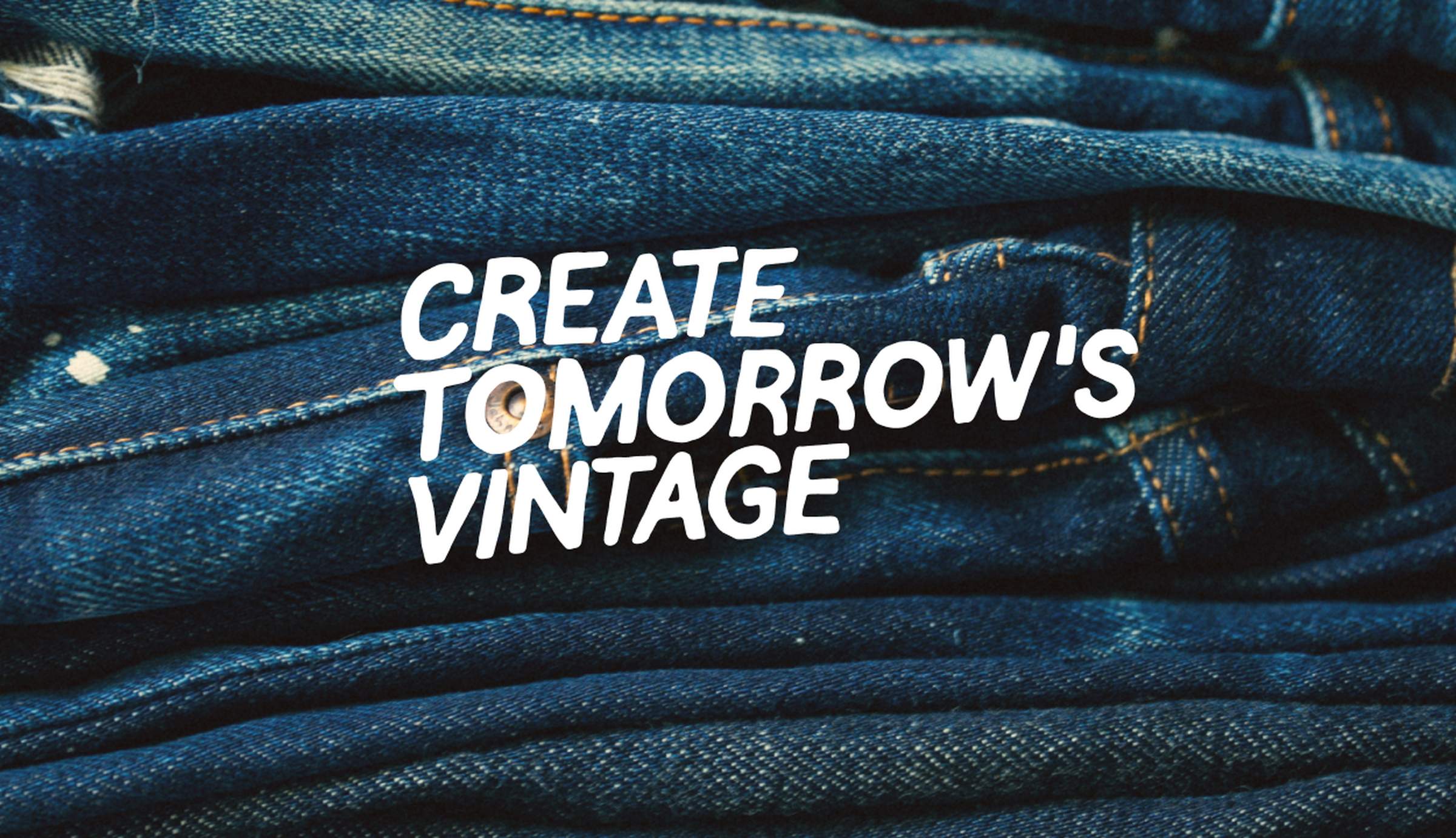 Stack of folded dark indigo Nudie Jeans denim with "Create Tomorrow's Vintage" text overlay.