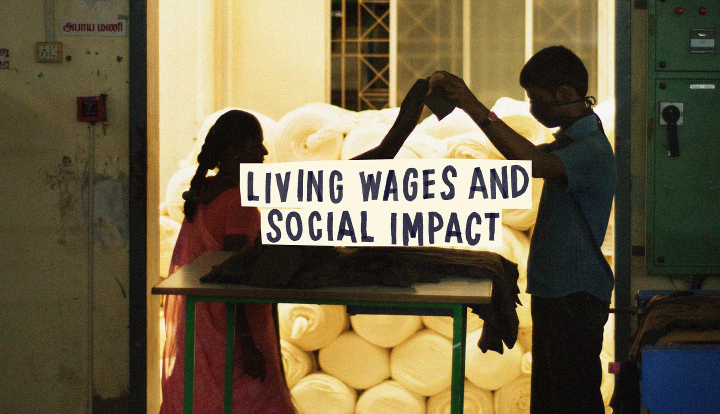 Two people folding fabric in a dimly lit room with rolls of material in the background, with text overlay: "Living Wages and Social Impact."
