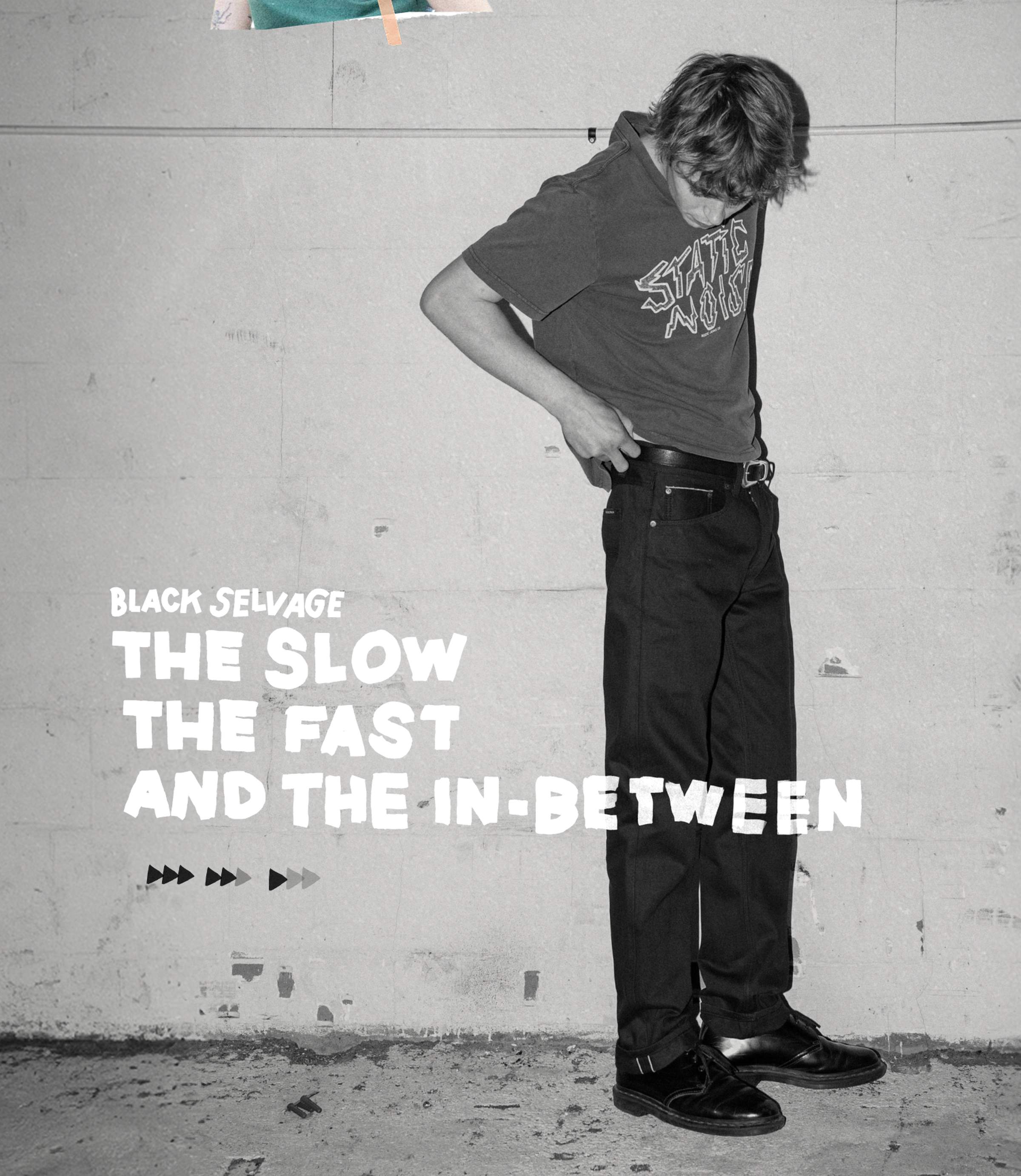 A person wearing a "STATE AMMO" shirt and black jeans stands against a wall with text reading "BLACK SELVAGE THE SLOW THE FAST AND THE IN-BETWEEN."