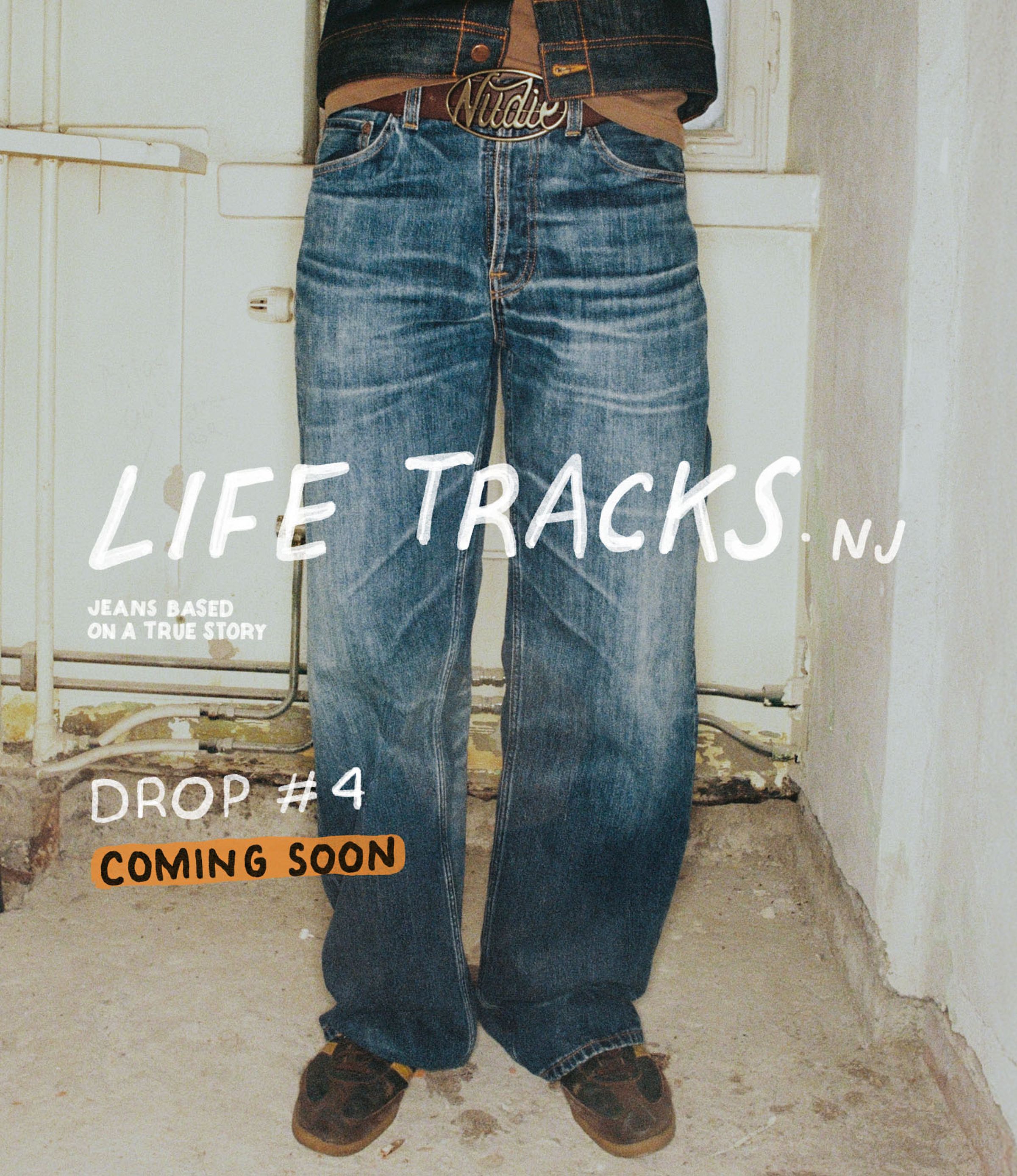 Person wearing wide-leg jeans and a brown belt, standing in front of a door. Text reads "Life Tracks NJ; Drop #4 Coming Soon."