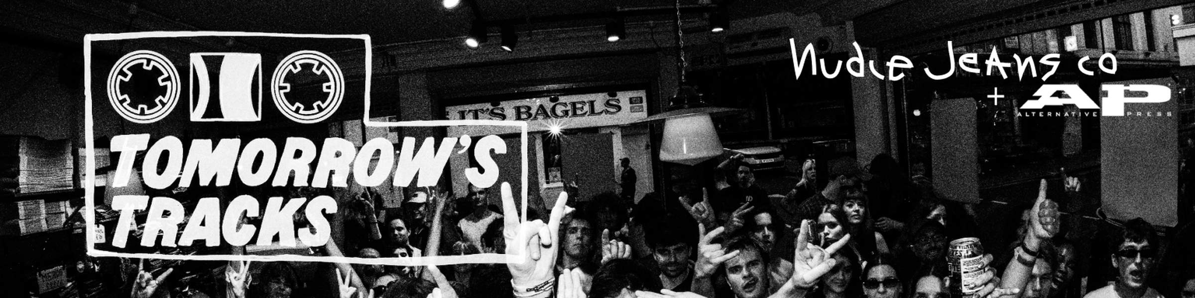A lively crowd at a music event, with logos for "Tomorrow's Tracks," "Nudie Jeans Co," and "Alternative Press" in a black and white setting.
