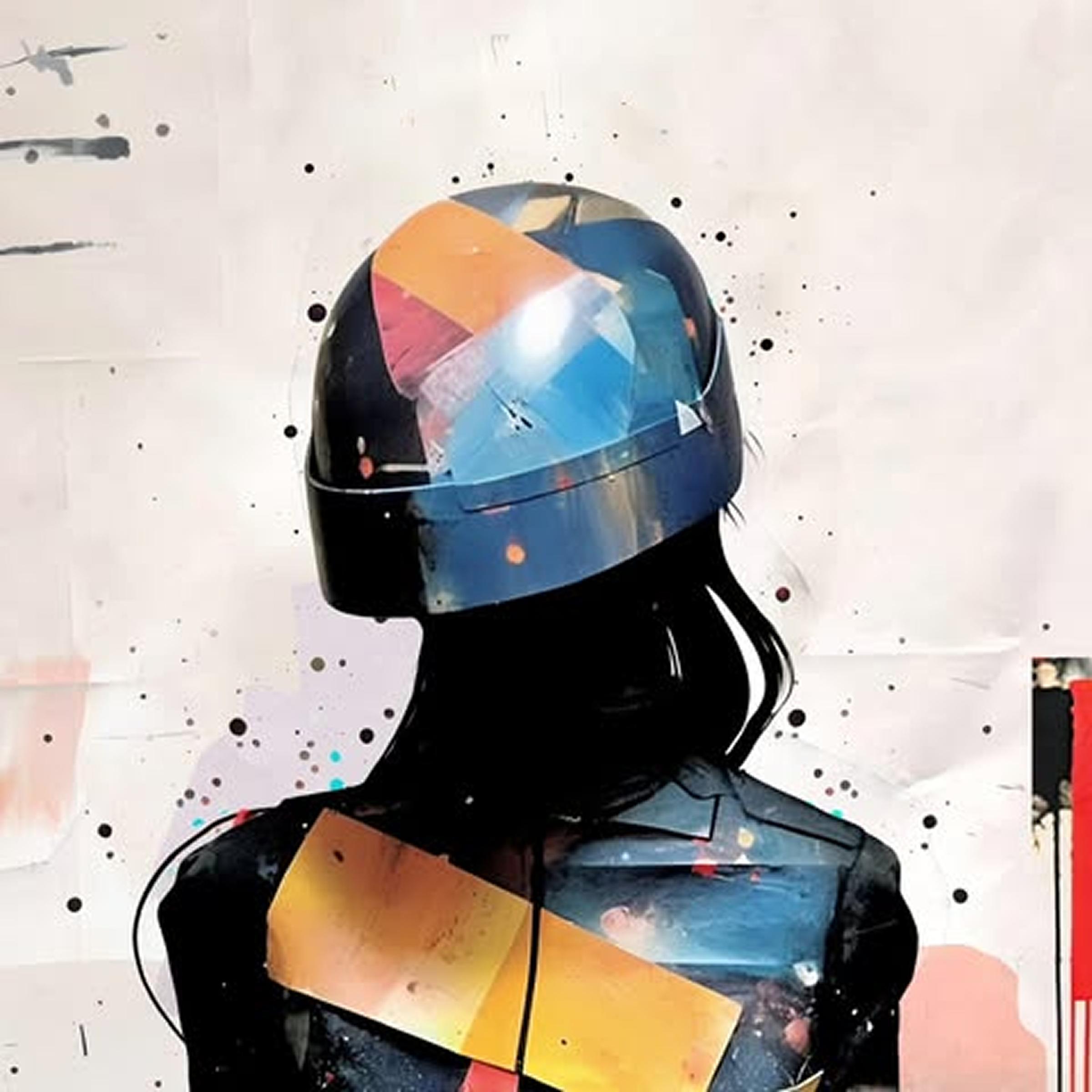 A person wearing a colorful, abstractly painted helmet and jacket stands against a splattered, artistic background.
