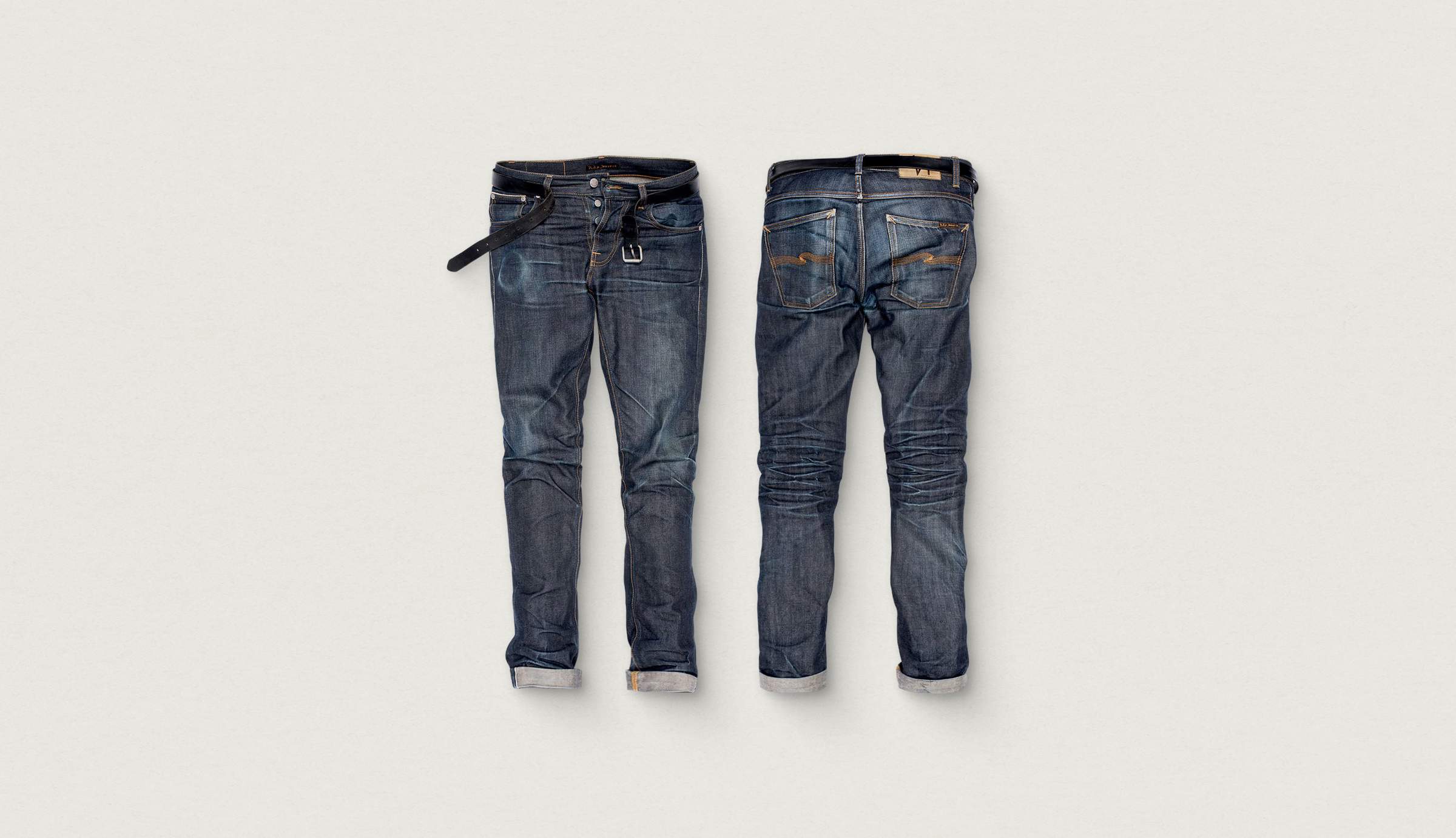 Front and back view of blue denim jeans with a black belt, featuring faded details and rolled cuffs, displayed on a plain background.