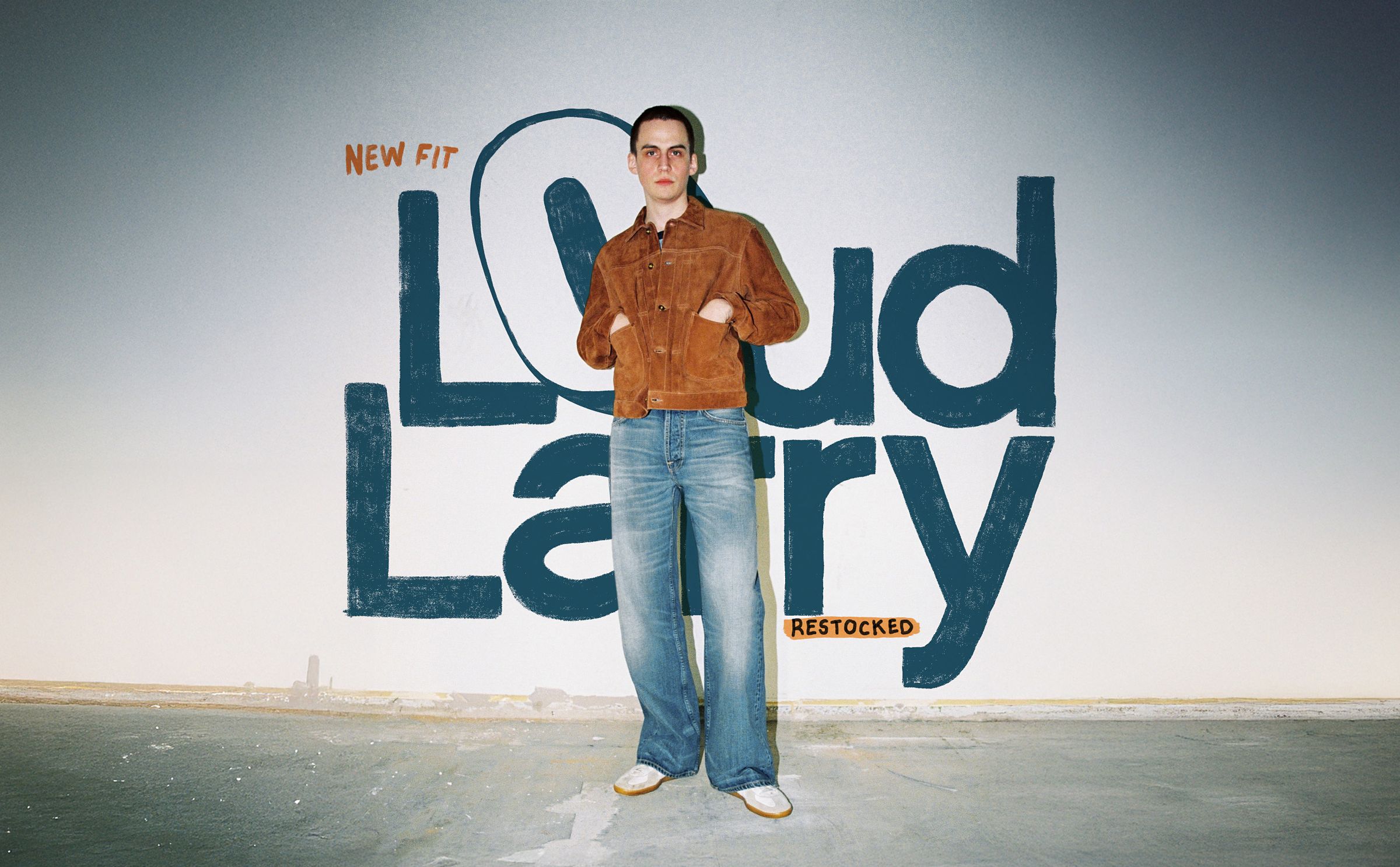 Person in brown jacket and wide-leg jeans stands in front of a wall with "Loud Larry" text. Background has a minimalist design.