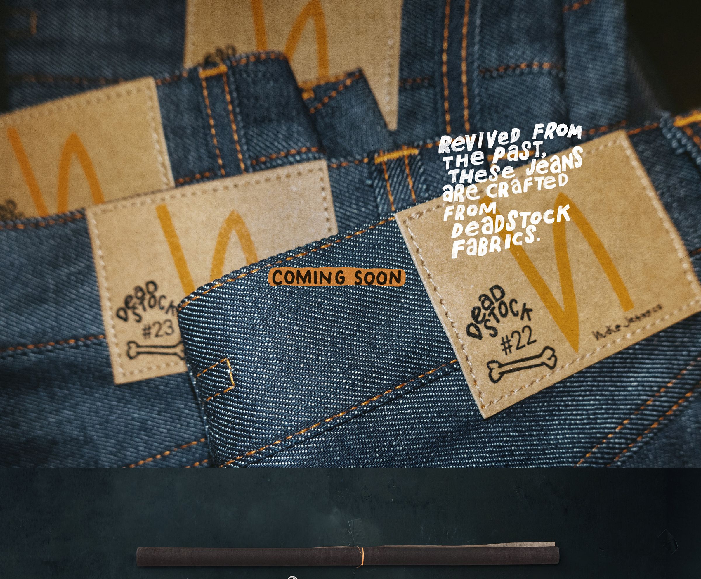 Close-up of denim jeans showcasing labels with "Deadstock" and product numbers. Text reads, "Revived from the past. Coming soon."
