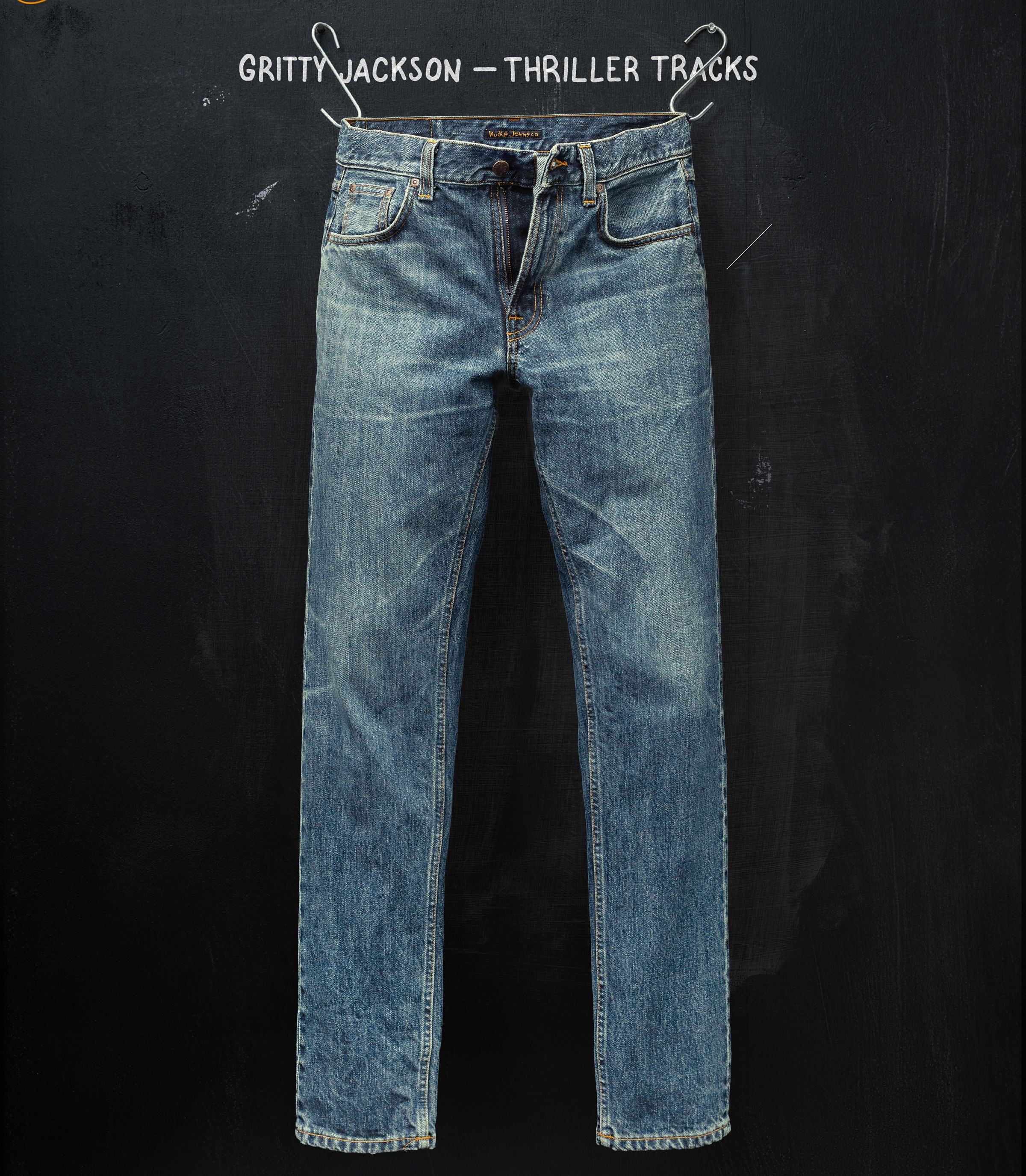 Faded blue jeans hanging against a dark background, with text "Gritty Jackson - Thriller Tracks" at the top.