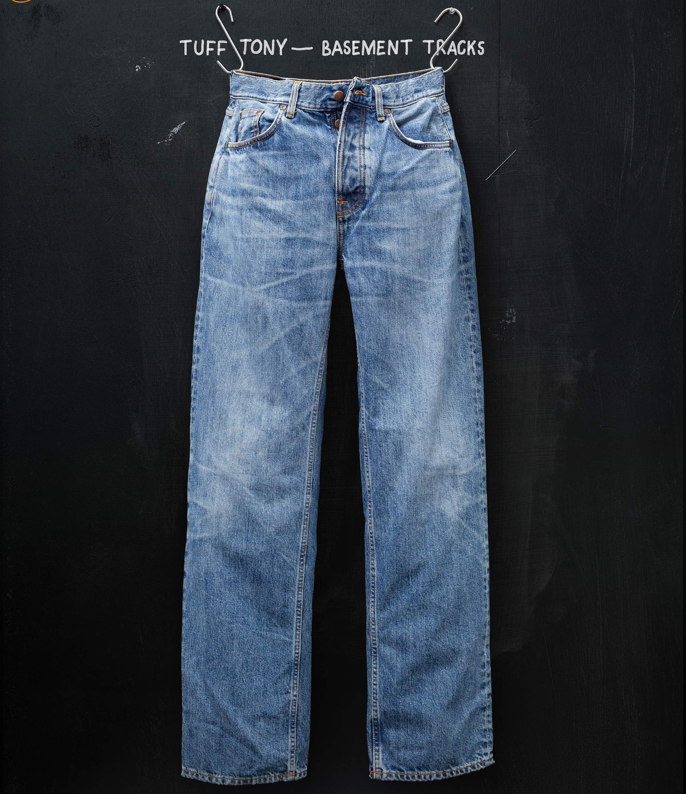 Faded blue jeans hanging against a black background with the text "TUFF TONY — BASEMENT TRACKS" above.