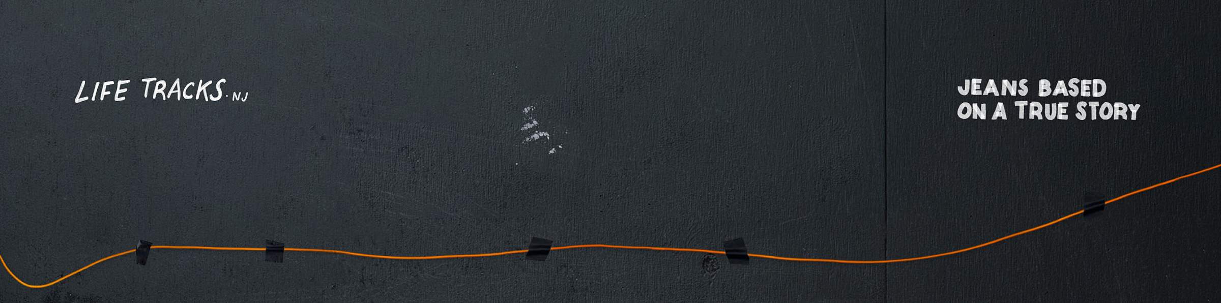 Black background with an orange line taped in a zigzag pattern. Text: "LIFE TRACKS NJ" and "JEANS BASED ON A TRUE STORY."