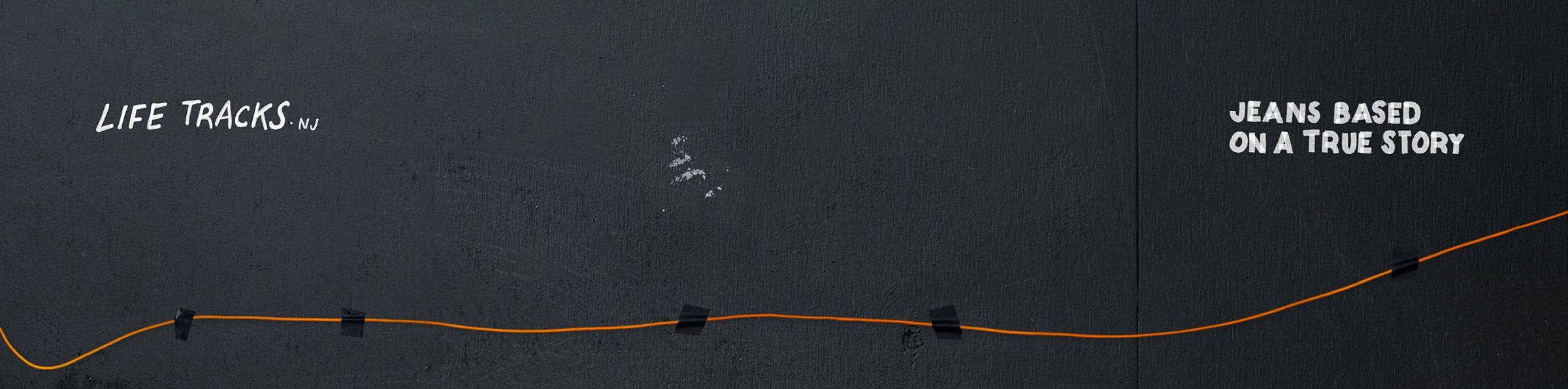 Black background with an orange line taped in a zigzag pattern. Text: "LIFE TRACKS NJ" and "JEANS BASED ON A TRUE STORY."