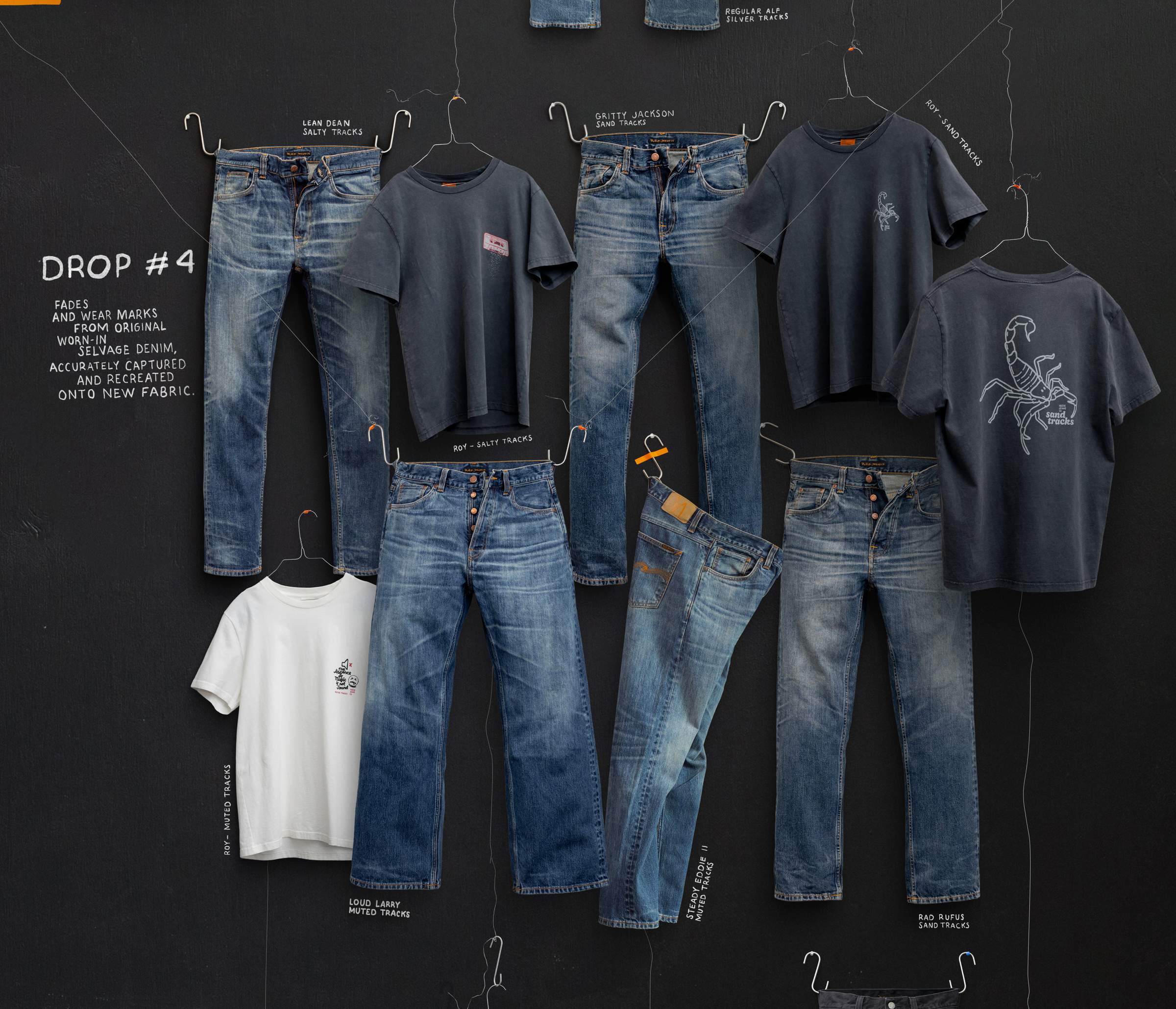 Nudie Jeans Life Tracks Drop #4 collection of worn-in selvedge denim jeans and faded t-shirts on hangers.