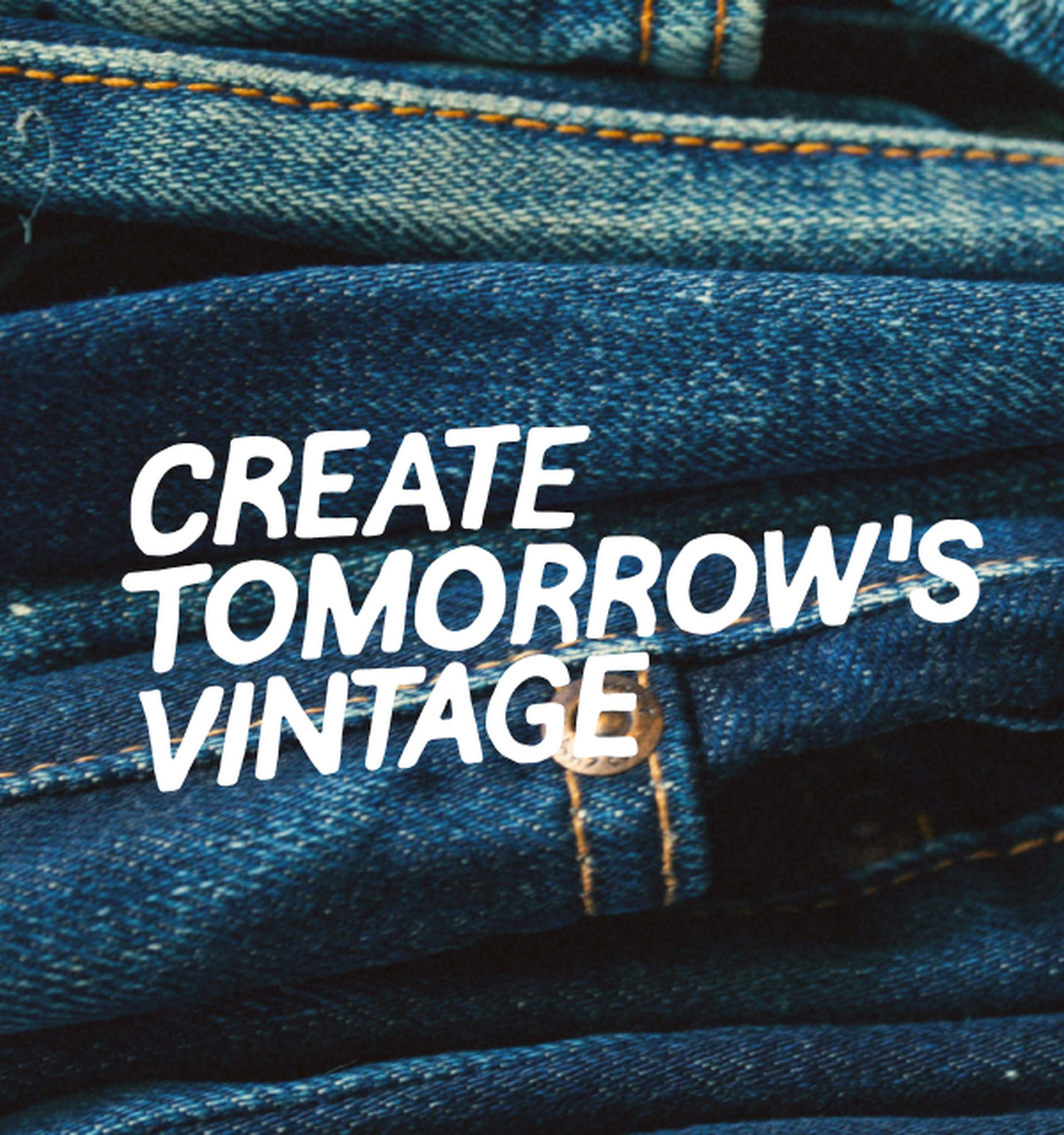 Close-up of stacked Nudie Jeans in dark indigo washes with orange stitching, text reads "Create Tomorrow's Vintage".