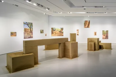 Rand Abdul Jabbar, <i>Tektōn (after Zaha, after Malevich)</i>, 2023, Pigment prints on Moab Entrada, clay and sand. Installation view, A Permanent Nostalgia for Departure: A Rehearsal on Legacy with Zaha Hadid. Photo: Wes Battoclette, 2023. Image courtesy of the Contemporary Arts Center, Cincinnati, OH.