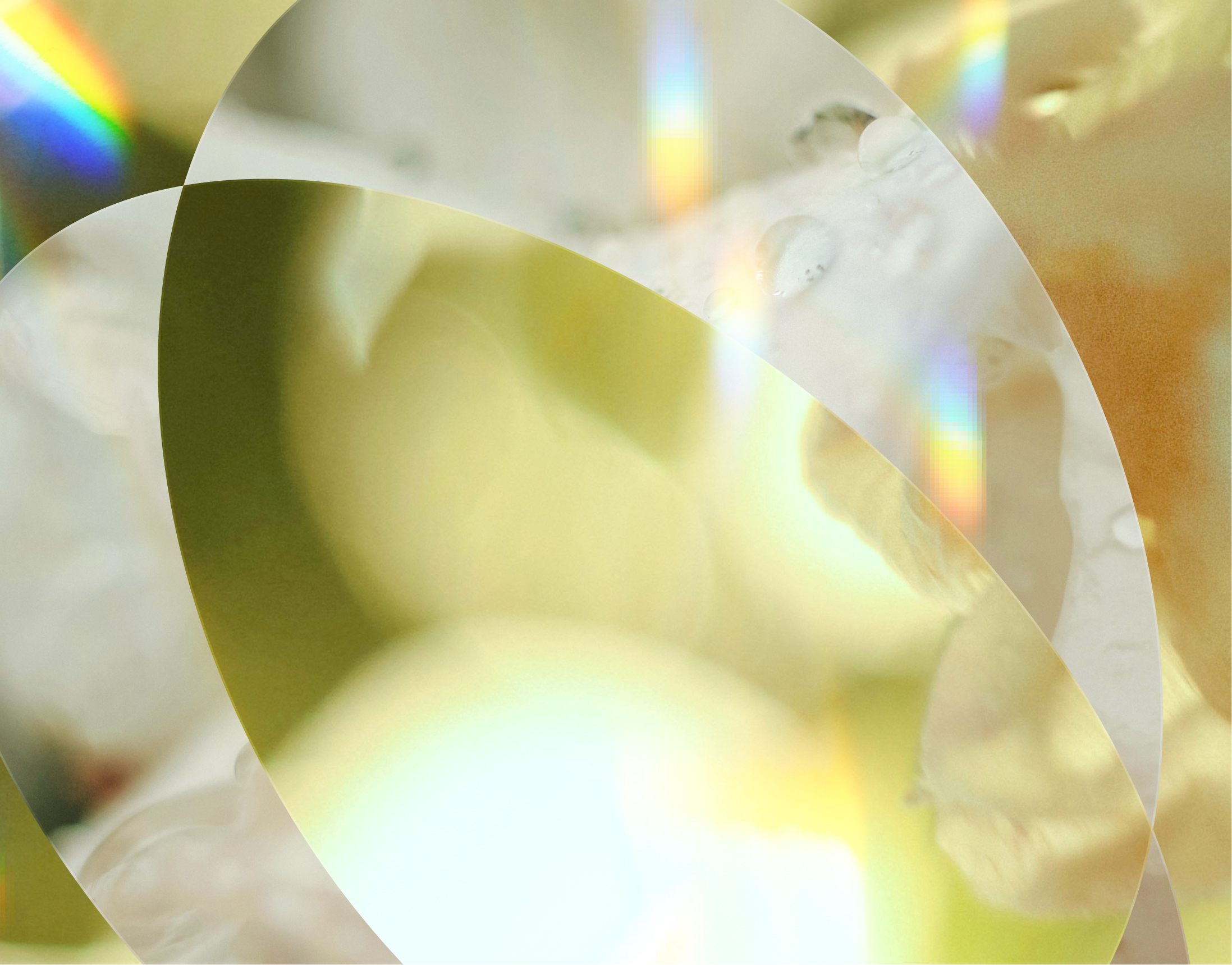 Abstract image with soft yellow hues, overlapping circles, water droplets, and subtle rainbow reflections, creating a dreamy, ethereal effect.