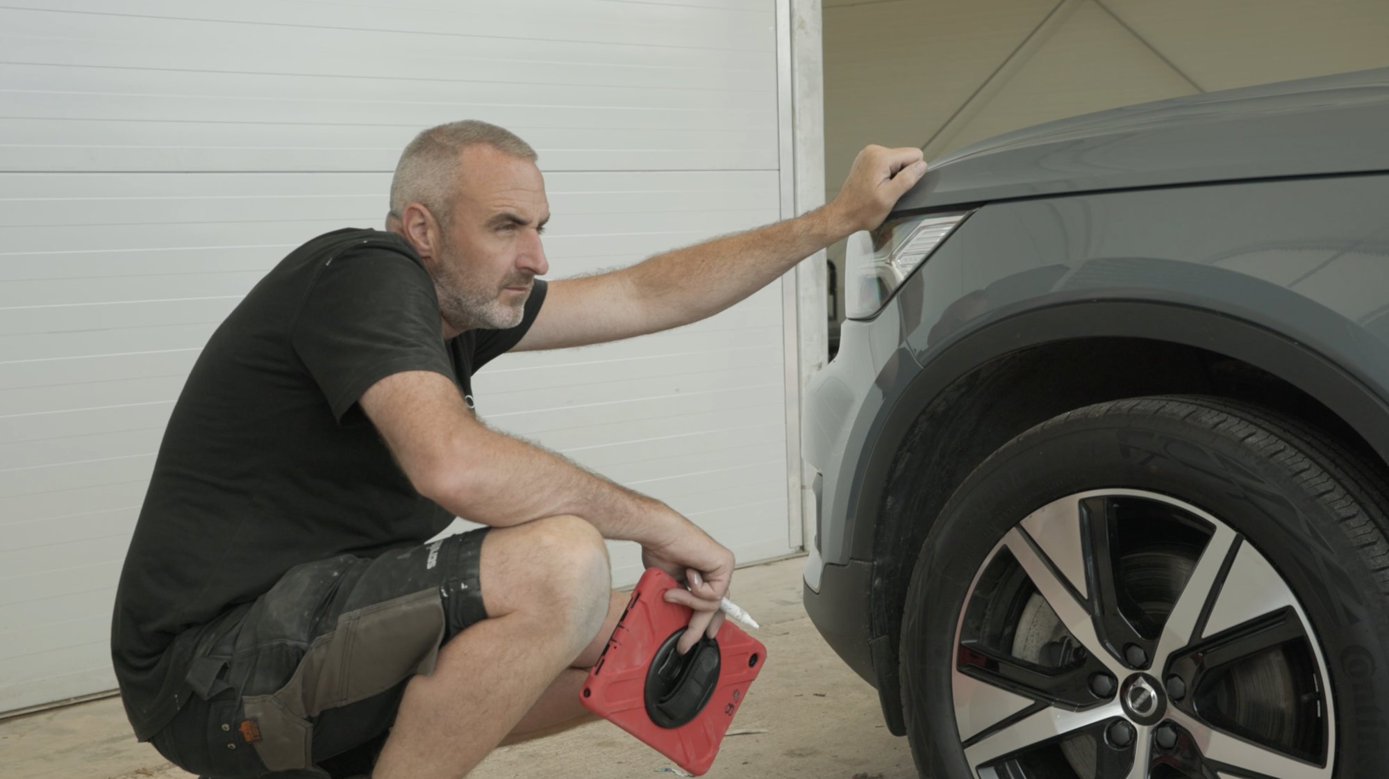 A car360 technician inspecting an EV at our collection centre