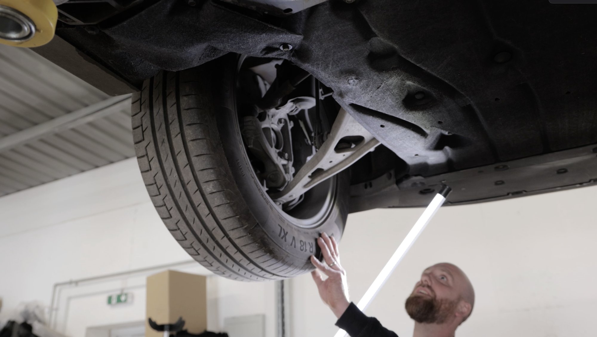 A car360 technician inspecting an EV in our workshop