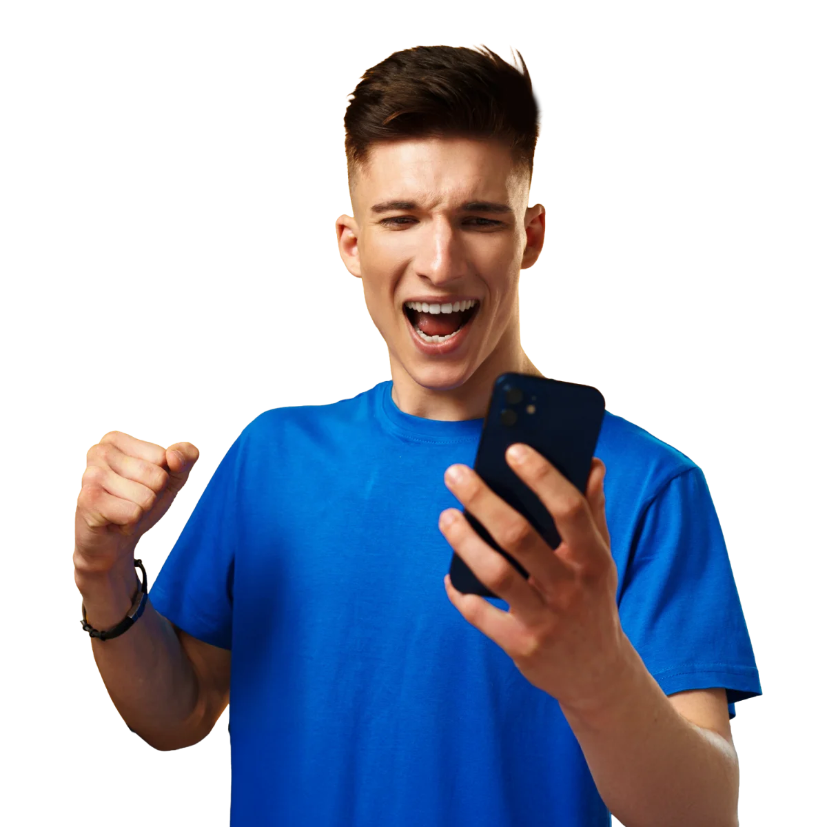 Young man in a blue shirt, excitedly looking at his phone, raising a fist in celebration against a plain background.