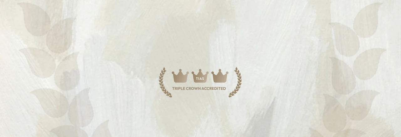TIAS Triple Crown Accredited logo with crowns and laurel wreaths on a textured beige background.