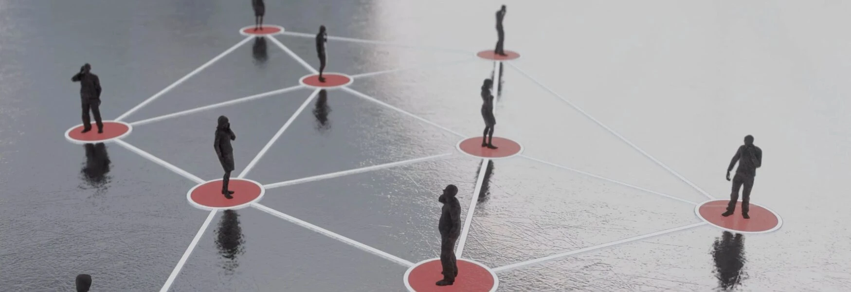 Silhouettes on connected red circles over a reflective surface, symbolizing network and communication.