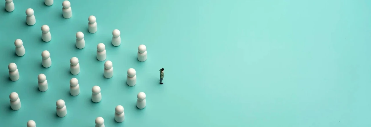 A lone figure faces a group of white game pieces arranged in formation on a teal background, symbolizing leadership or confrontation.