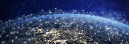 Aerial view of Earth at night with illuminated cities and digital network connections overlaying the surface.