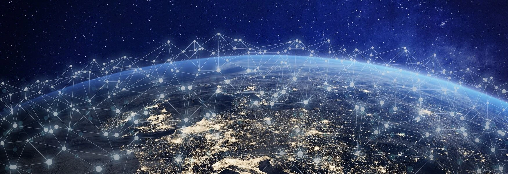 Aerial view of Earth at night with illuminated cities and digital network connections overlaying the surface.