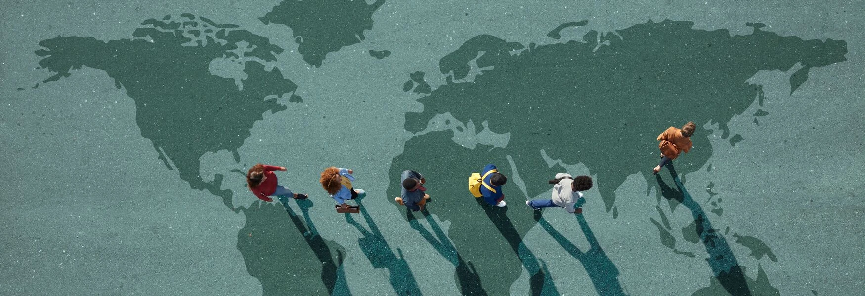 Group of young adults, photographed from above, on various painted tarmac surface, at sunrise.